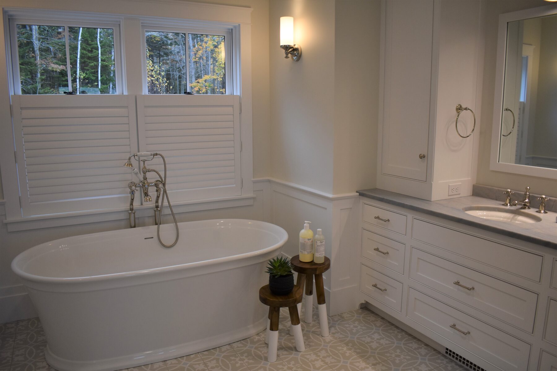 Soaking tub beside white bathroom vanity