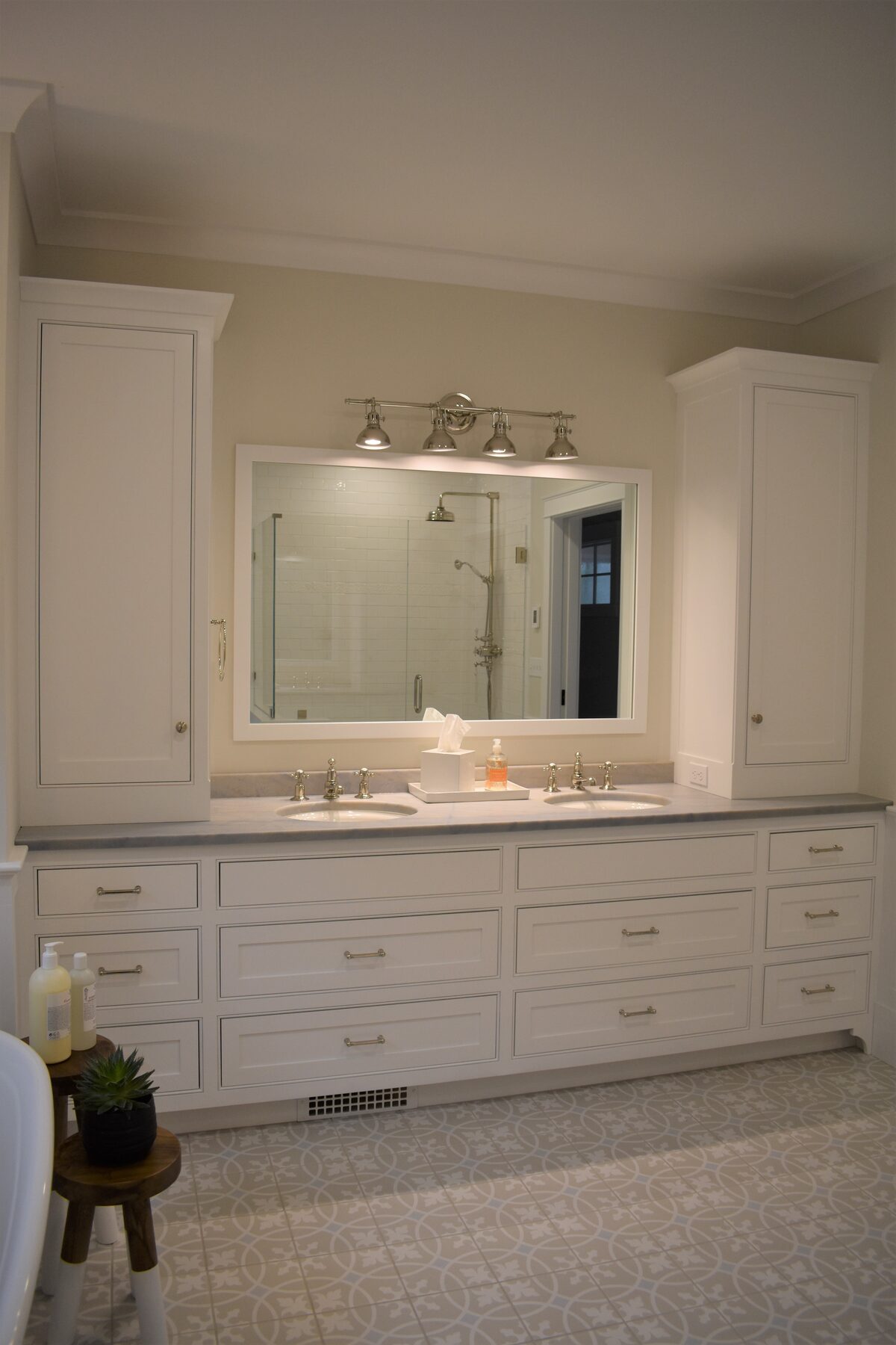 White bathroom vanity with mirror and wall sconces