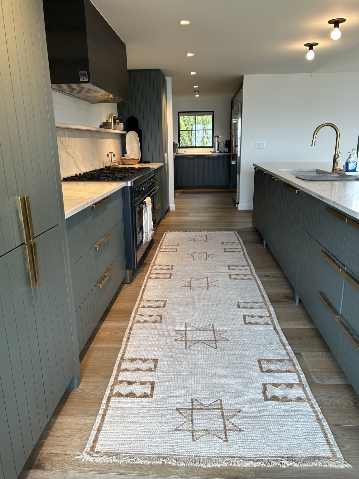 Blue-green kitchen galley view