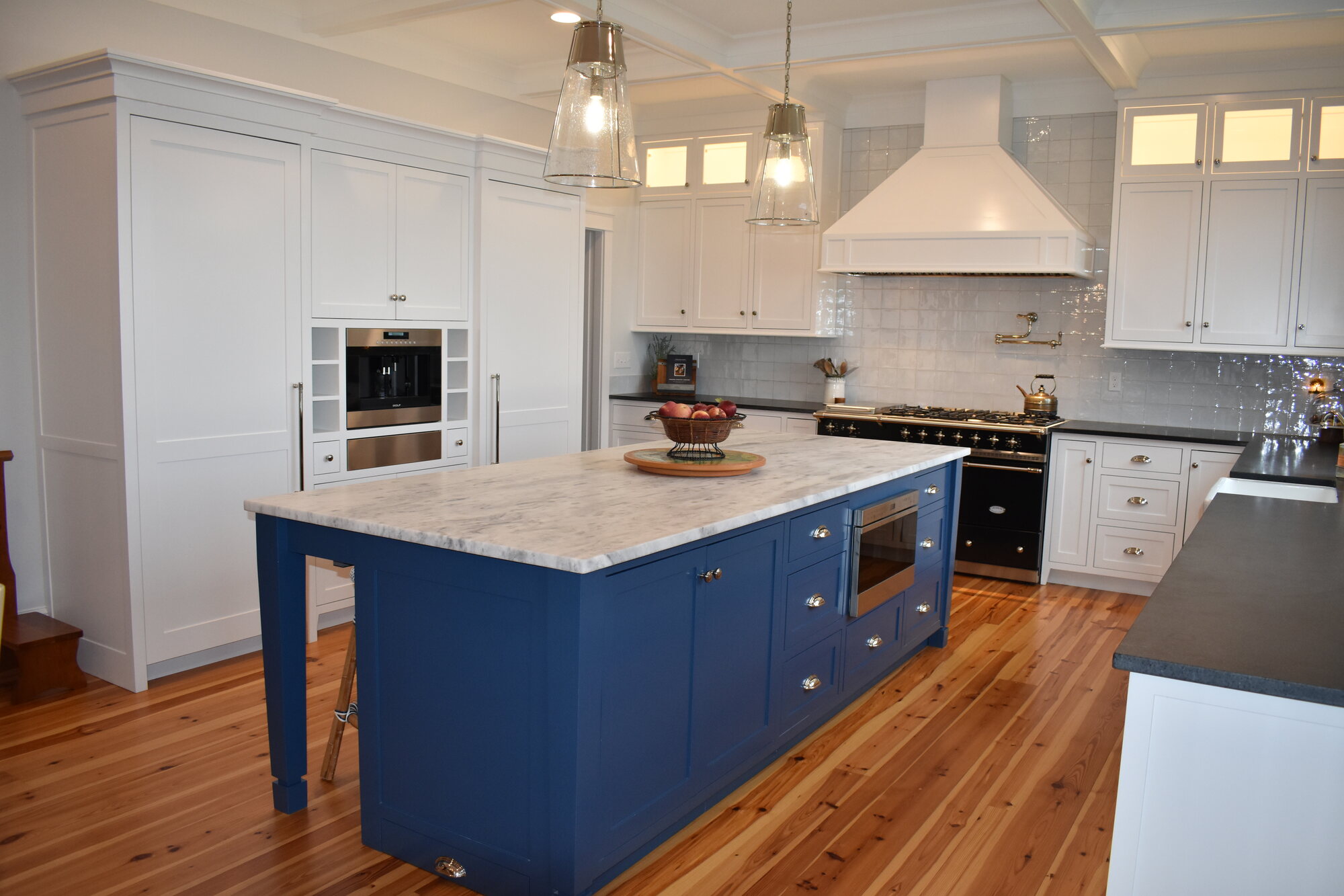 Blue island kitchen with range wall and white cabinetry