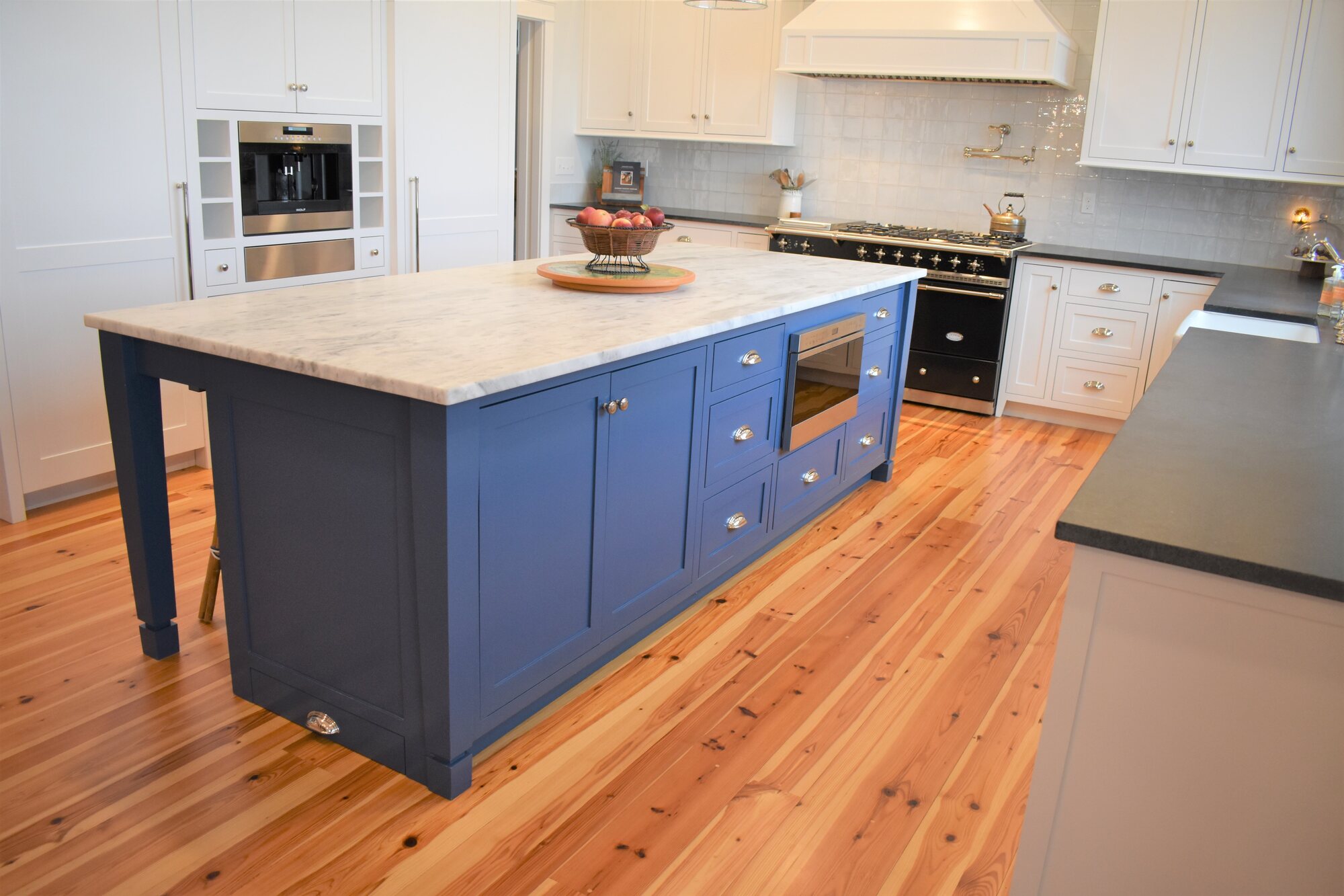 Blue kitchen island with butcher block top