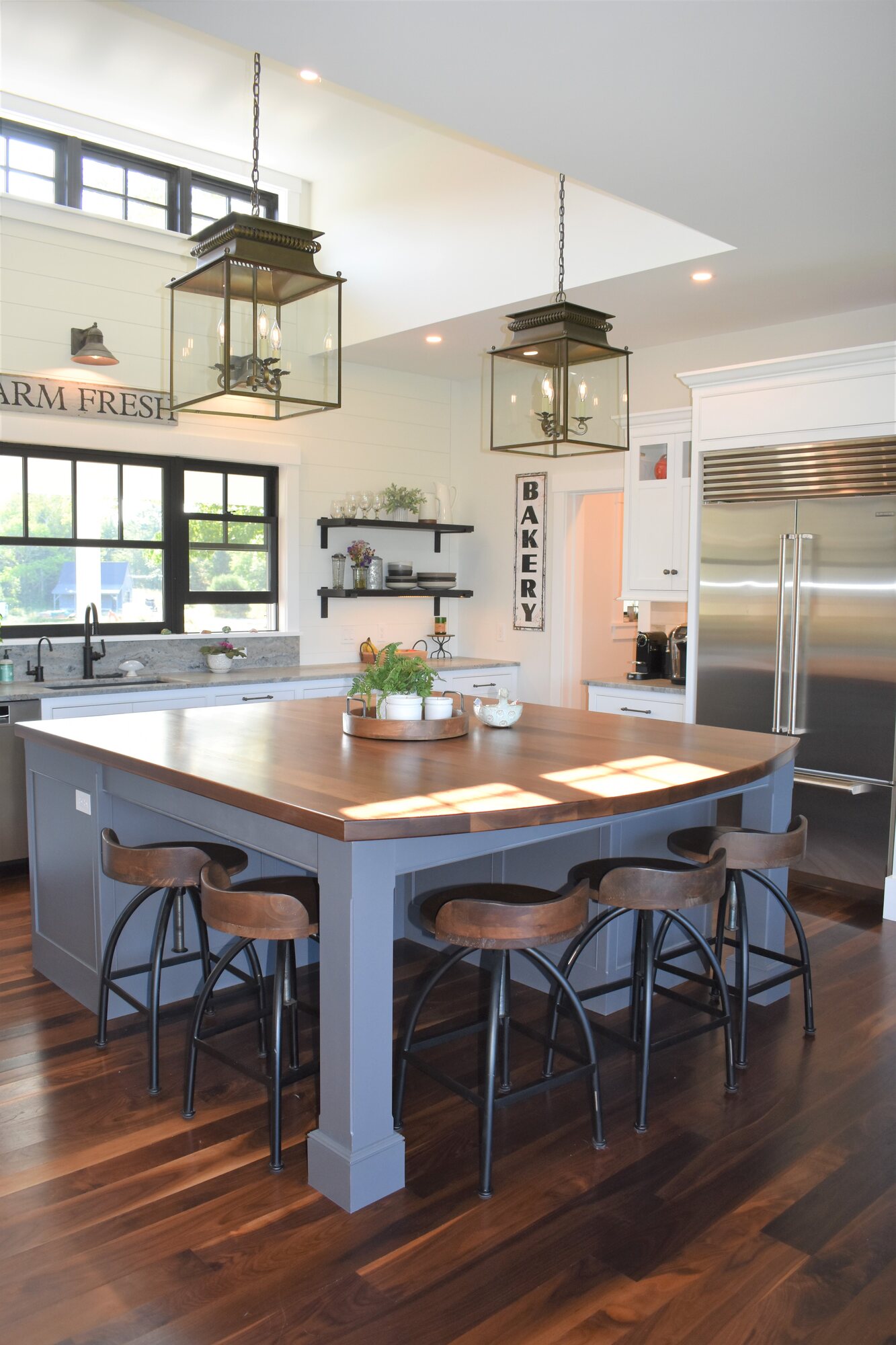 Blue island kitchen with seating and open shelving