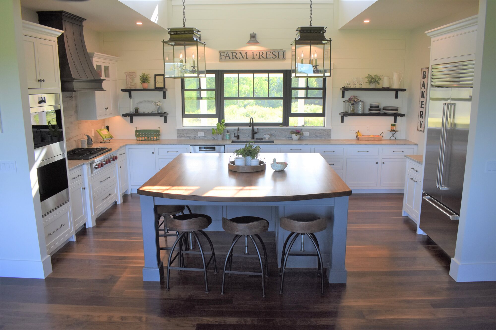Kitchen with blue island and open shelving