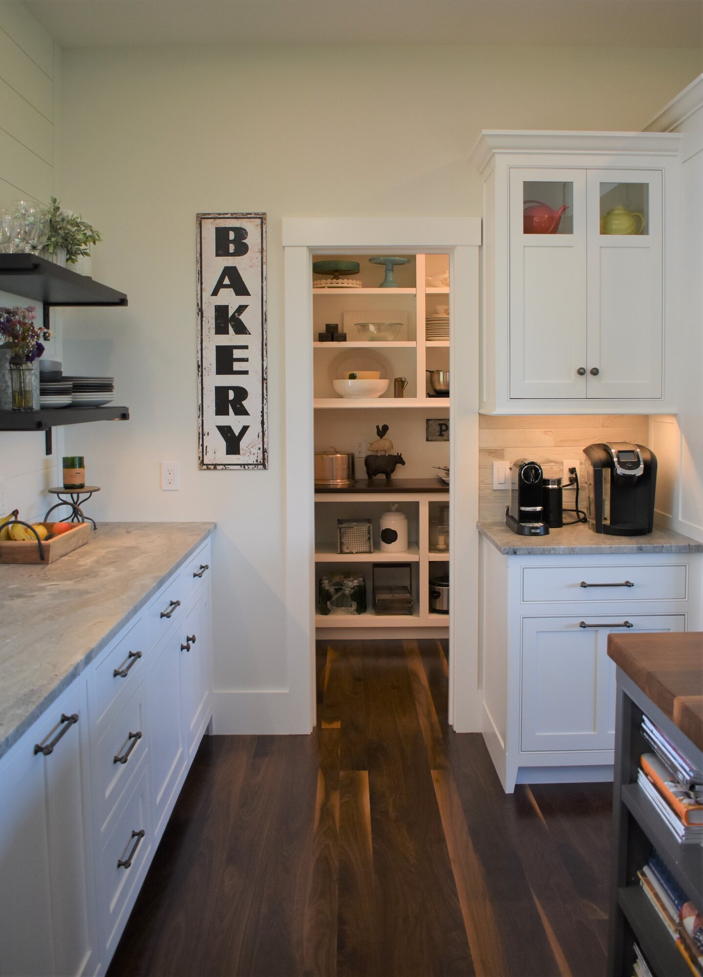 Kitchen pantry entry beside white cabinetry