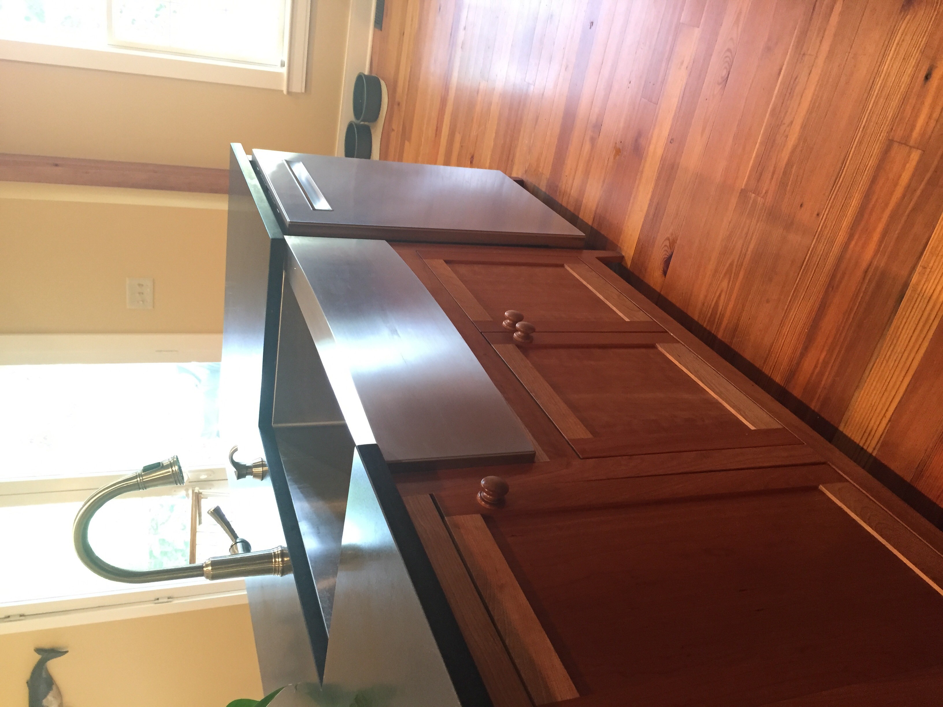 Cherry kitchen cabinetry detail beside sink
