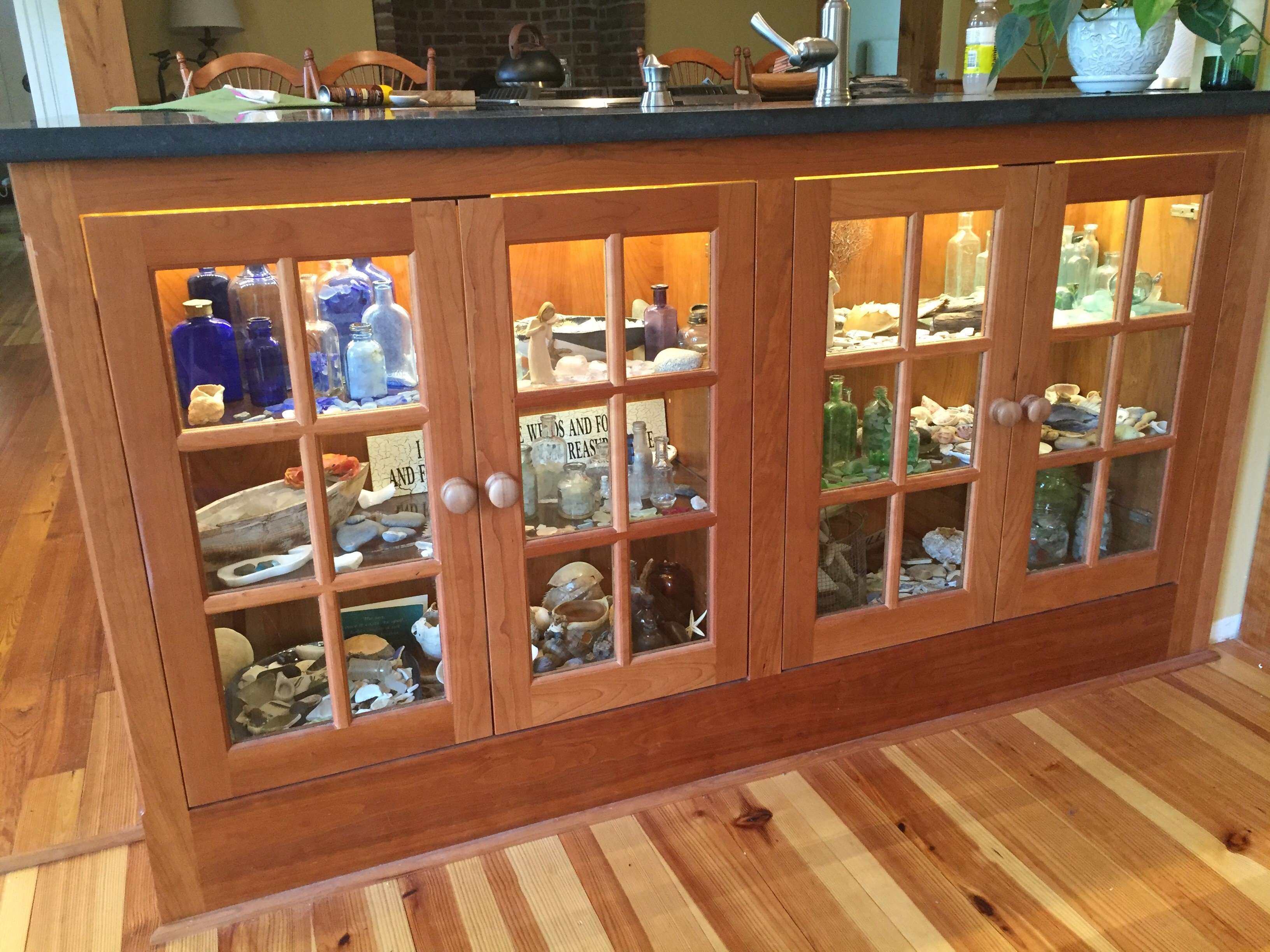 Cherry kitchen cabinetry with glass-front display cabinets