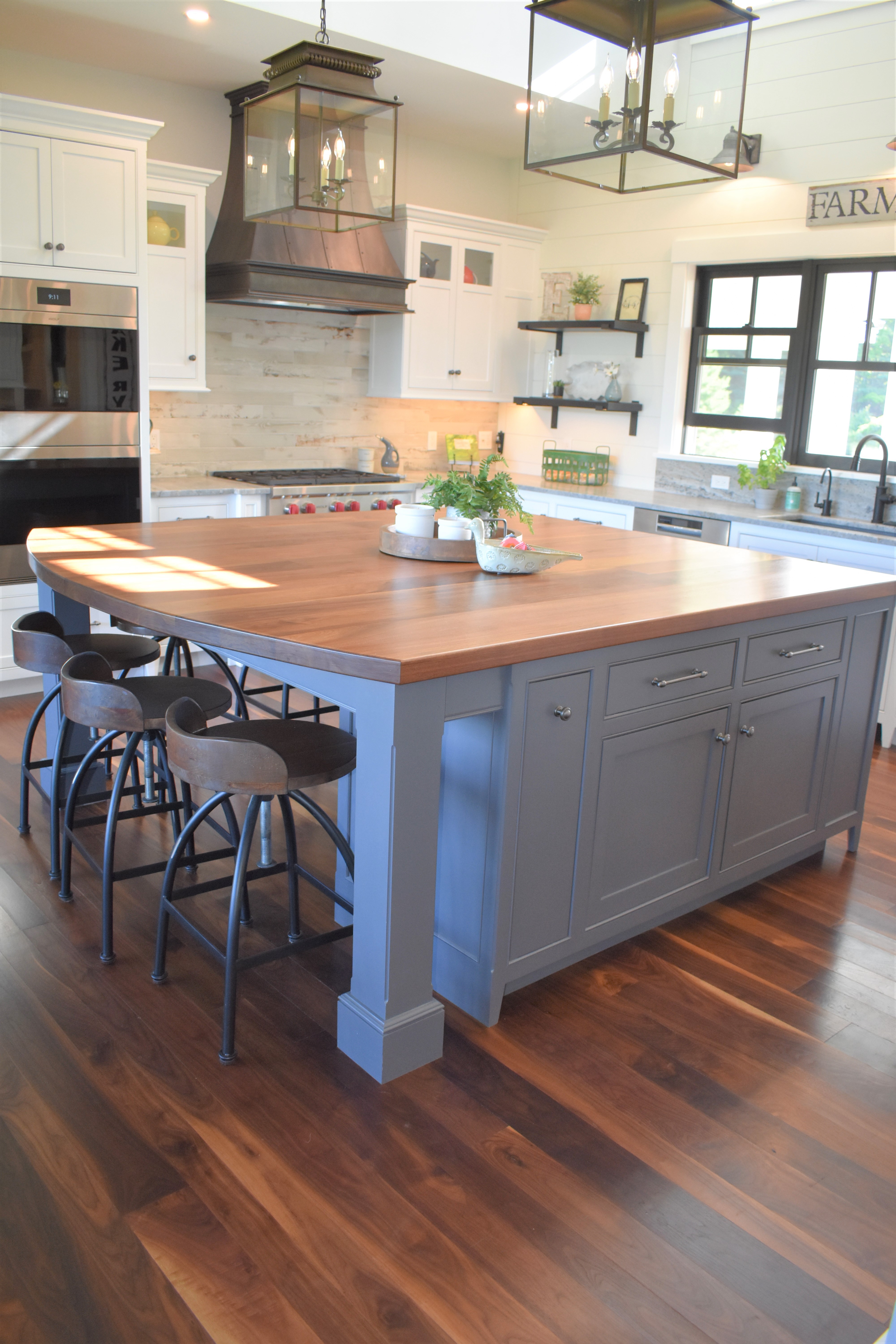 Classic kitchen island with wood countertop and bar seating