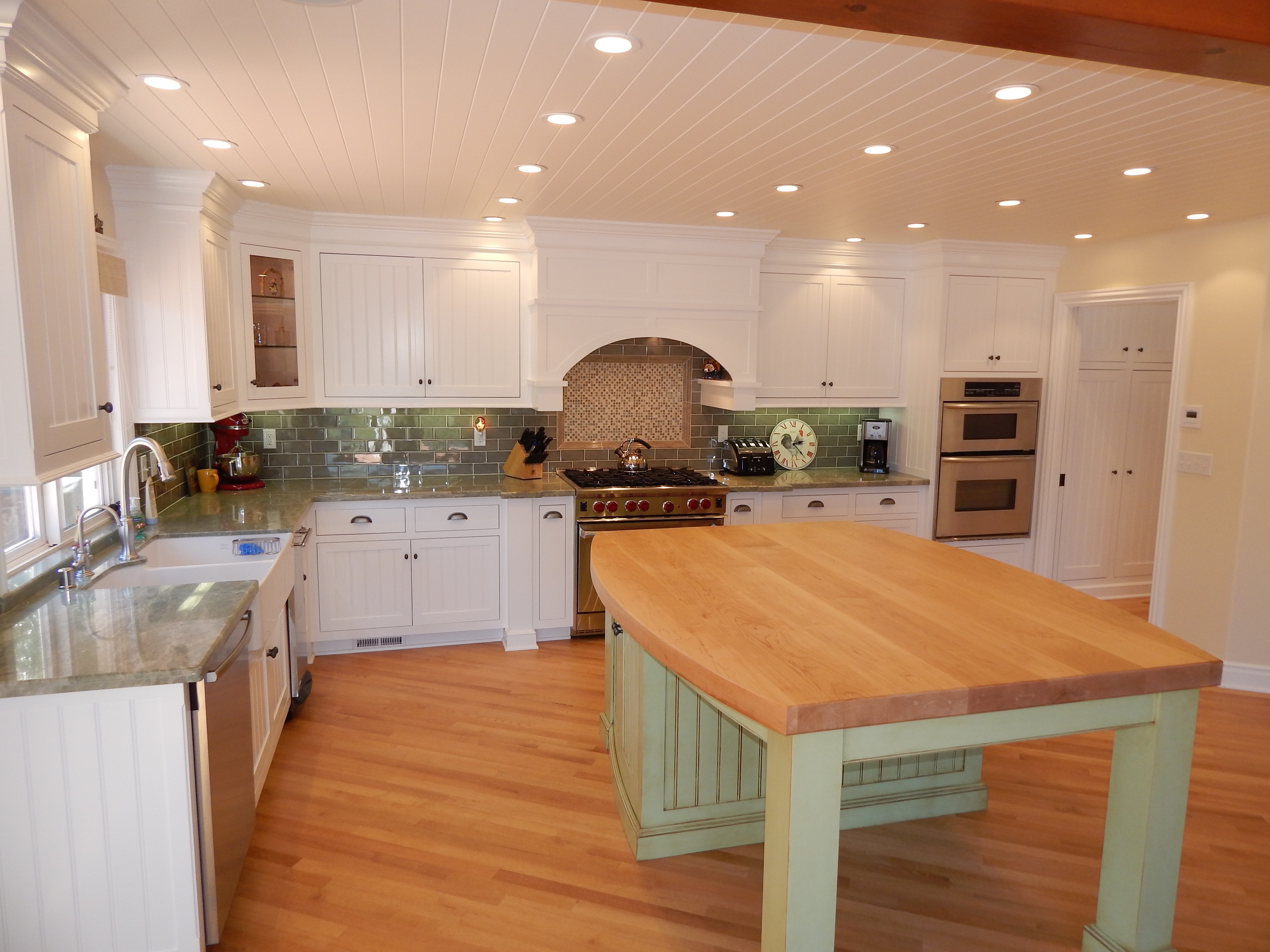 Dark wood kitchen with black island and paneled walls