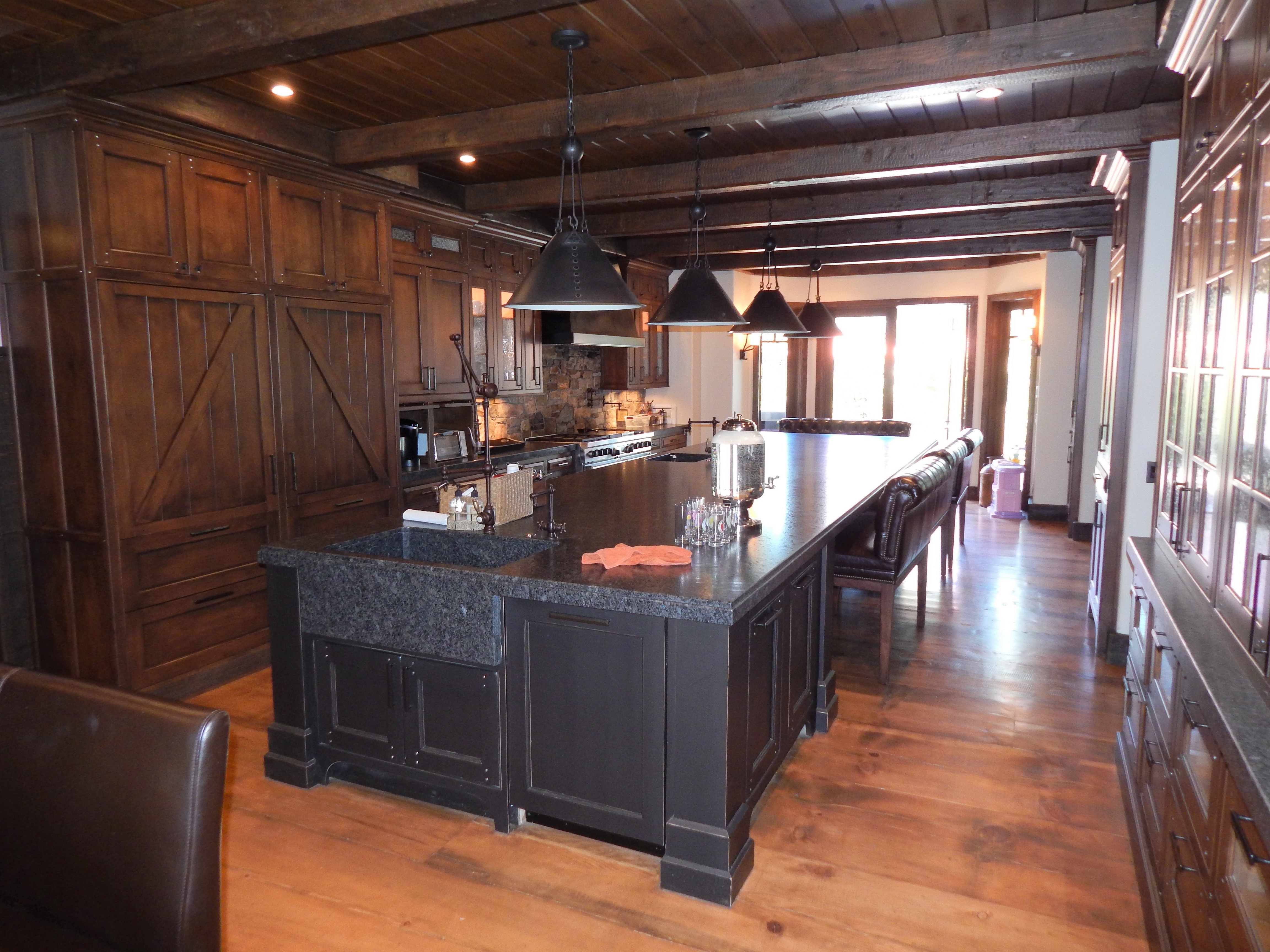 Painted kitchen with wood-topped island and arched range alcove