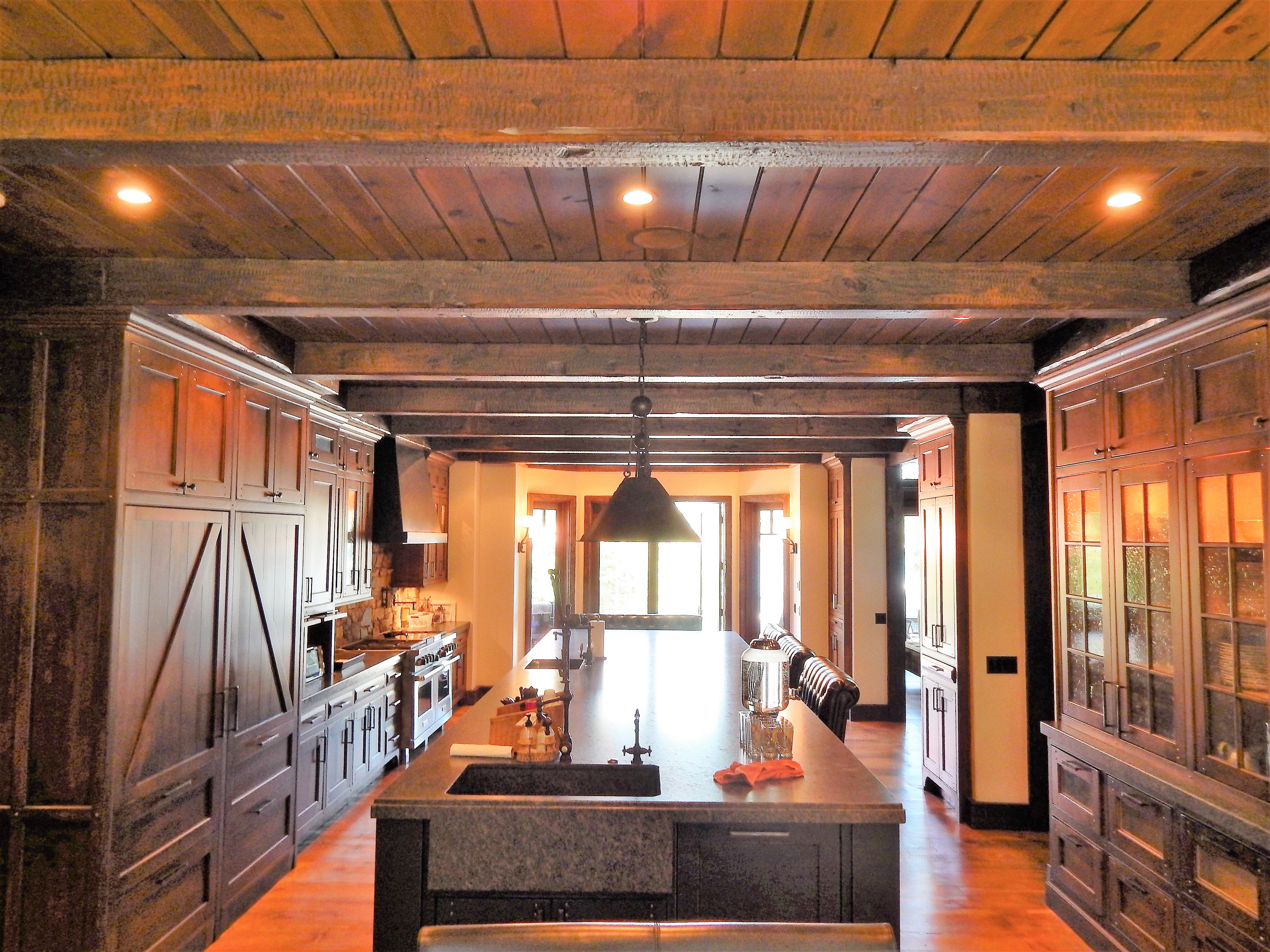 Dark wood kitchen with black island and detailed millwork