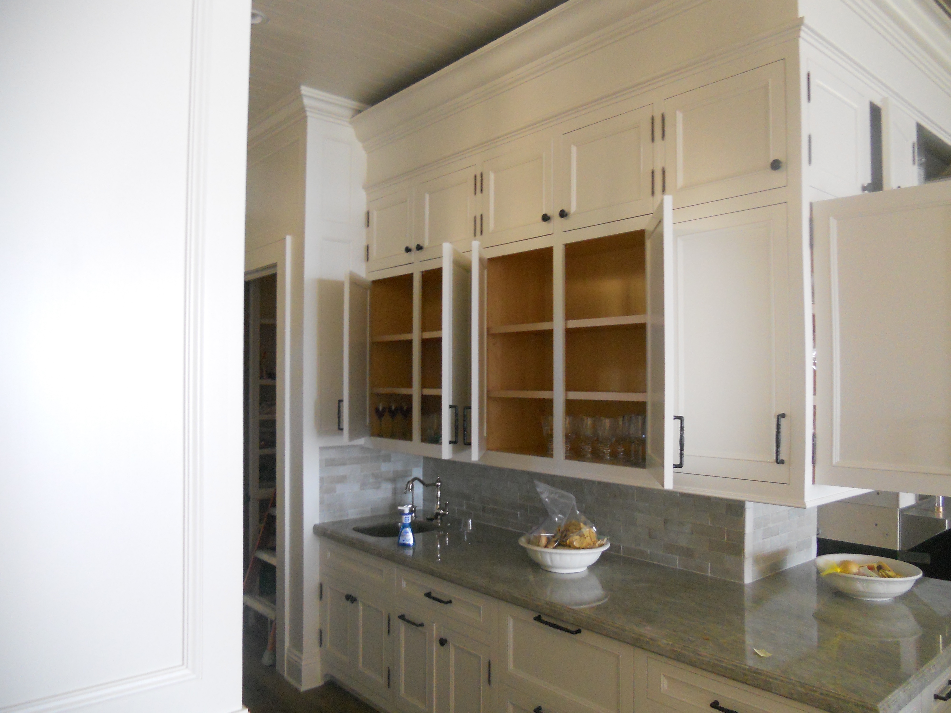 White kitchen hutch cabinetry with glass doors