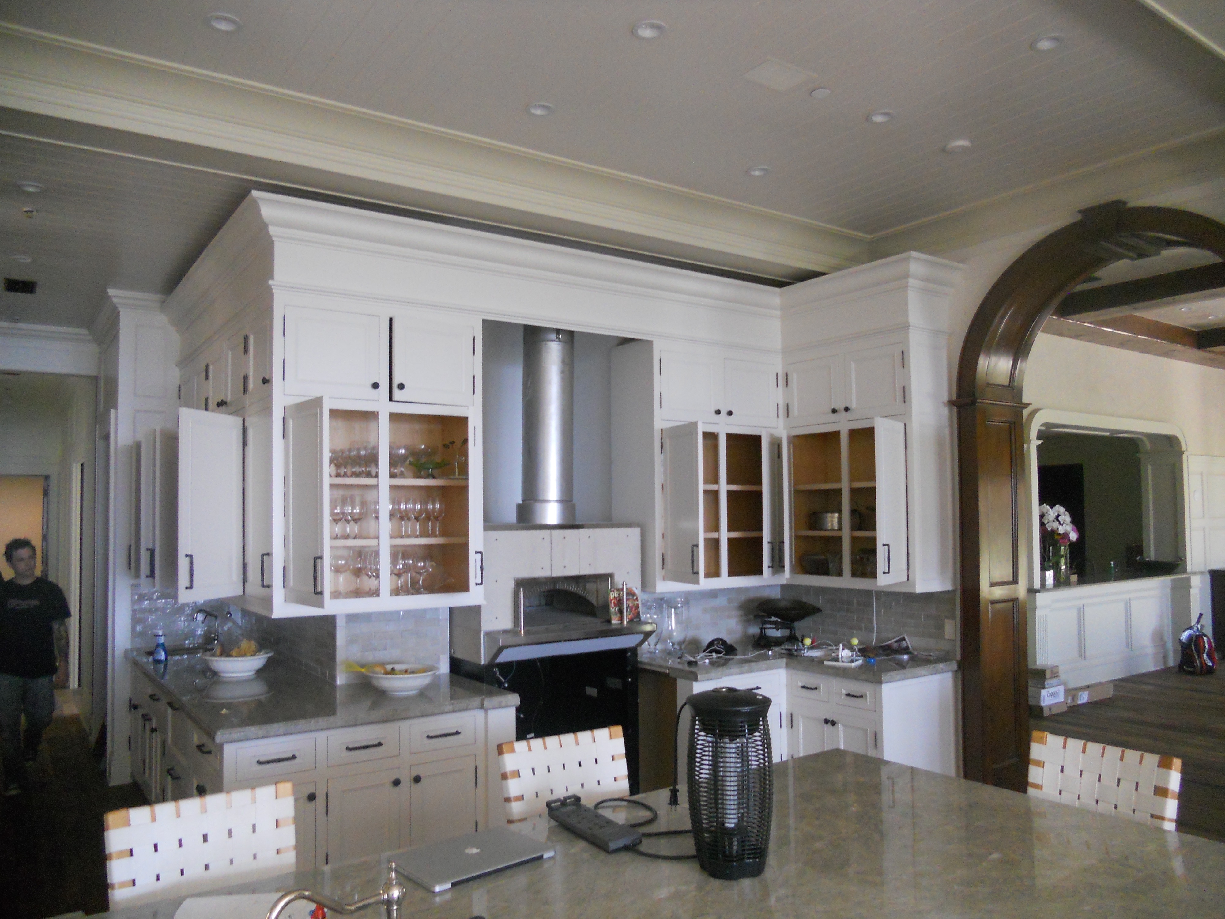 White kitchen display cabinet with glass doors and counter