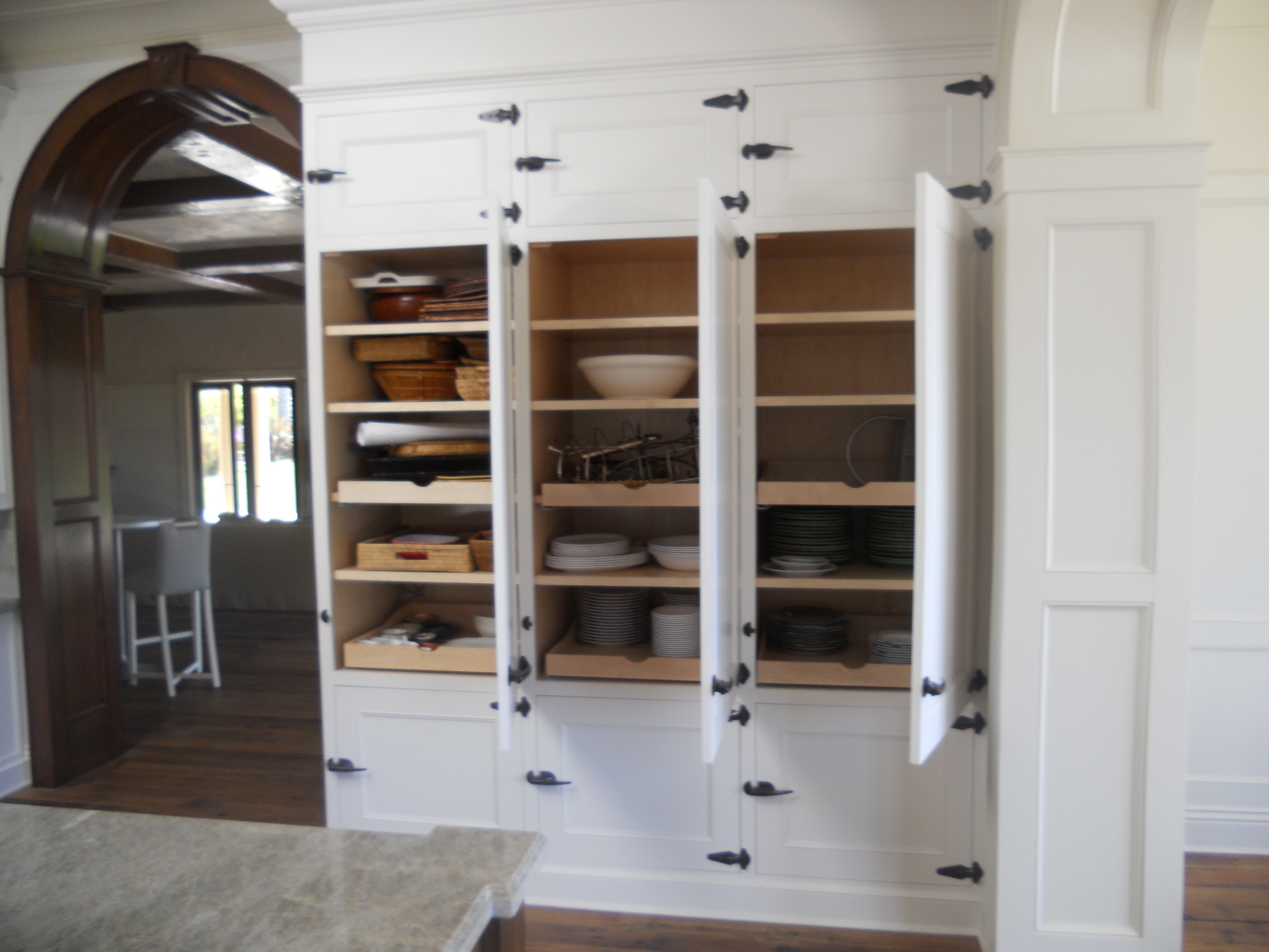 White pantry cabinetry with open shelves and lower storage