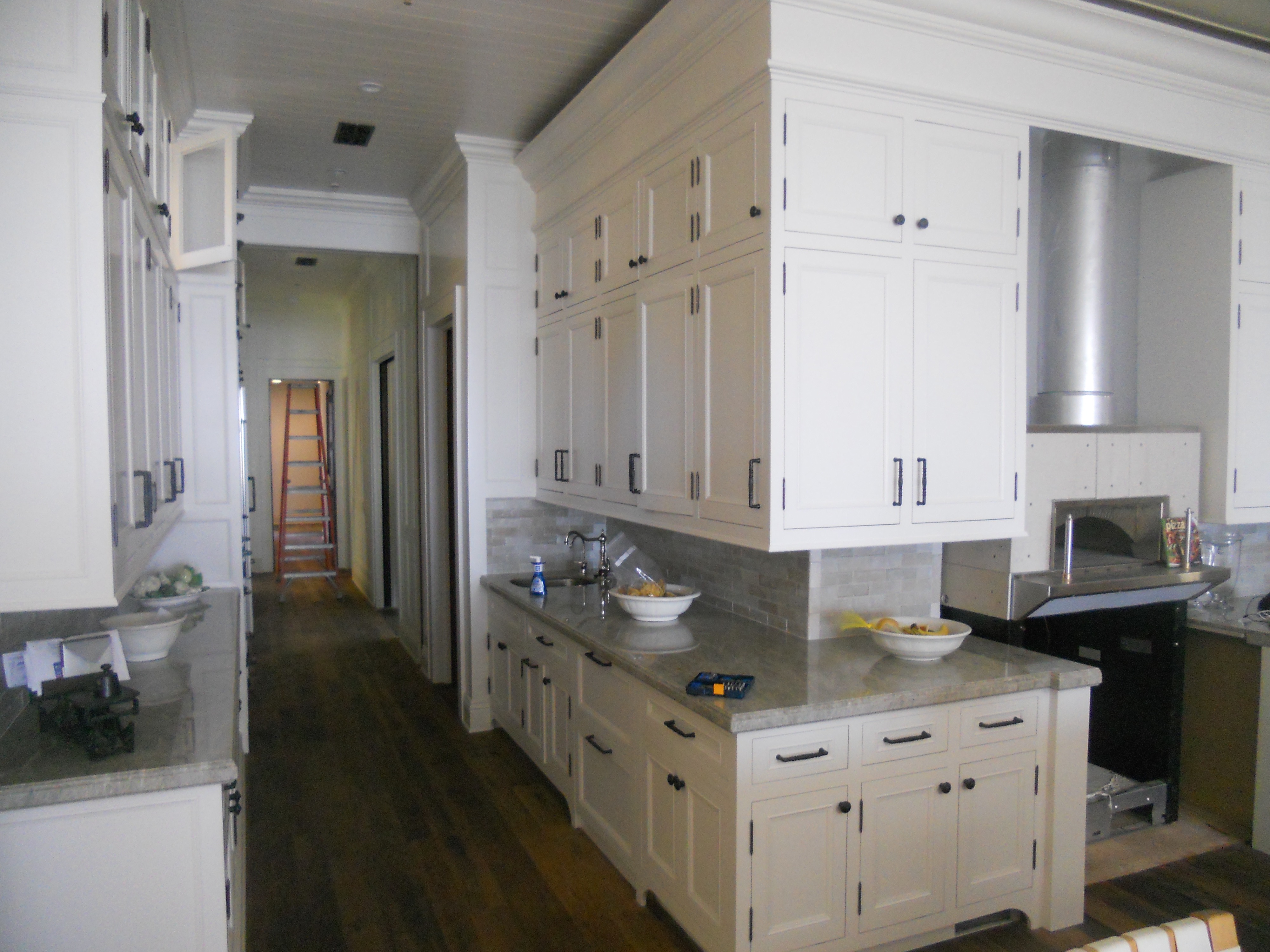 White kitchen counter wall with tall storage cabinetry