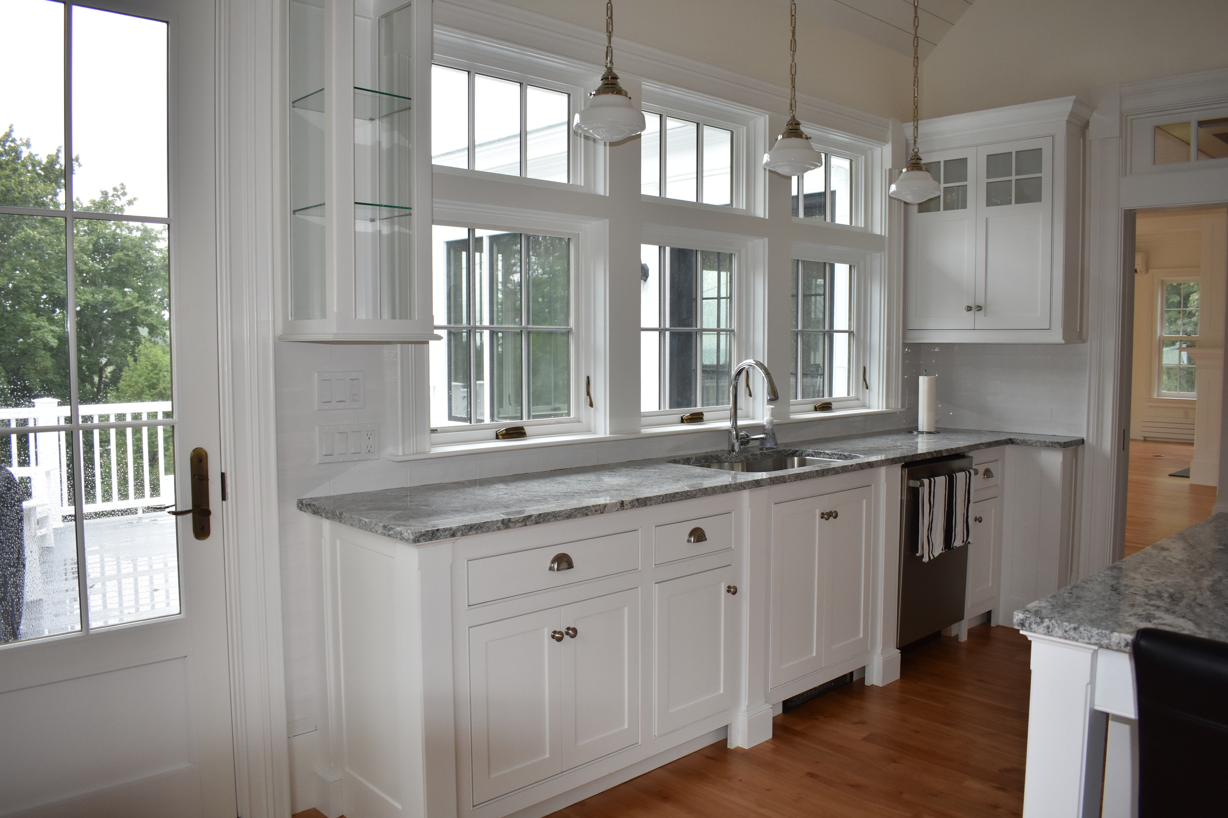 Coastal white kitchen with island and window wall