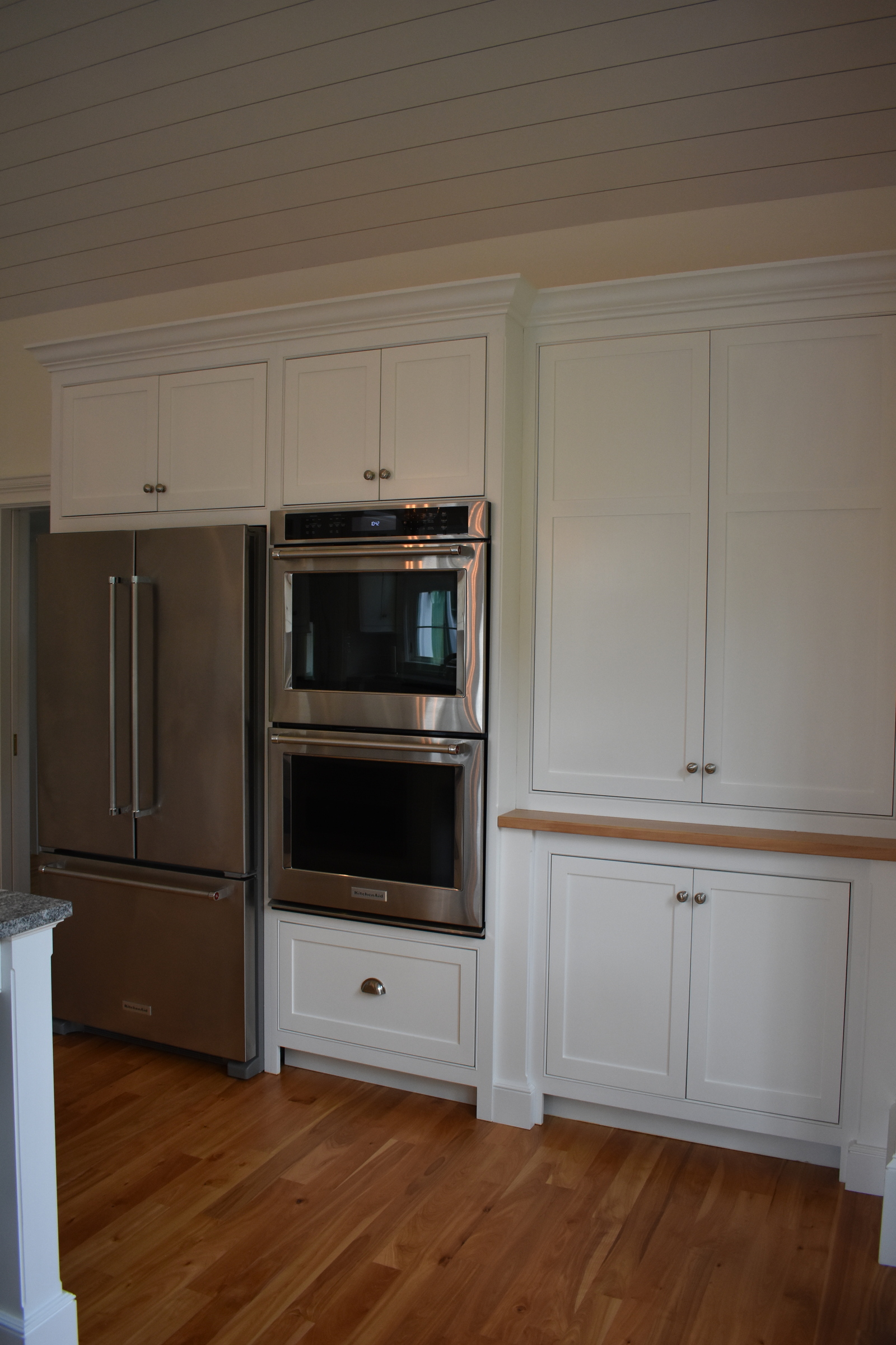 Coastal white kitchen refrigerator and appliance wall