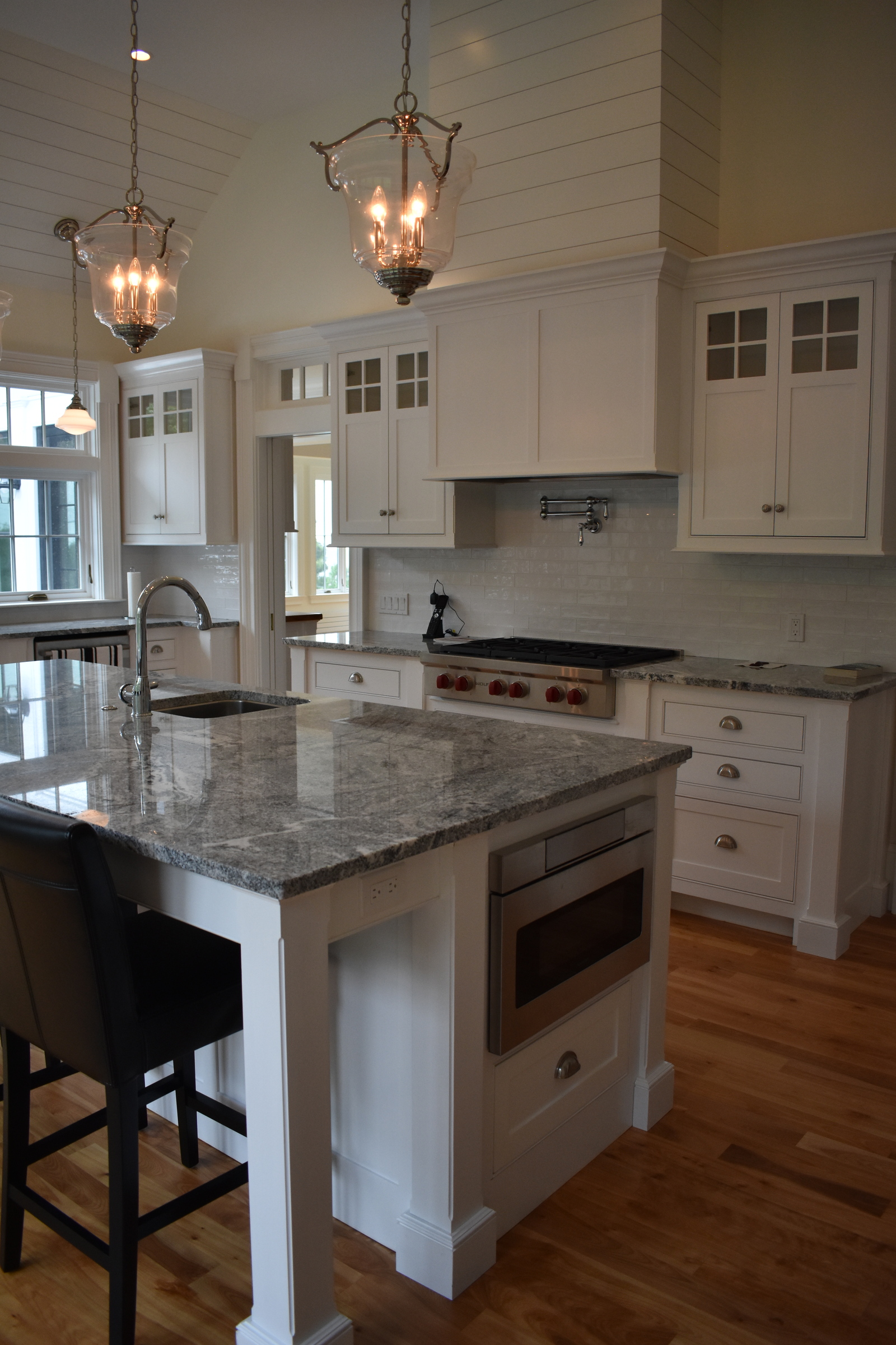 Coastal white kitchen island and pendant lighting