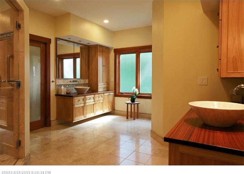 Floating natural wood vanity with vessel sink