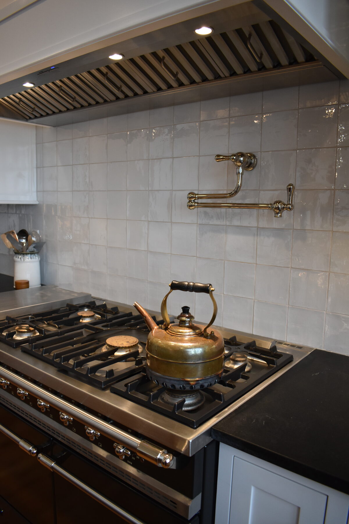 Kitchen range with custom hood and tile backsplash