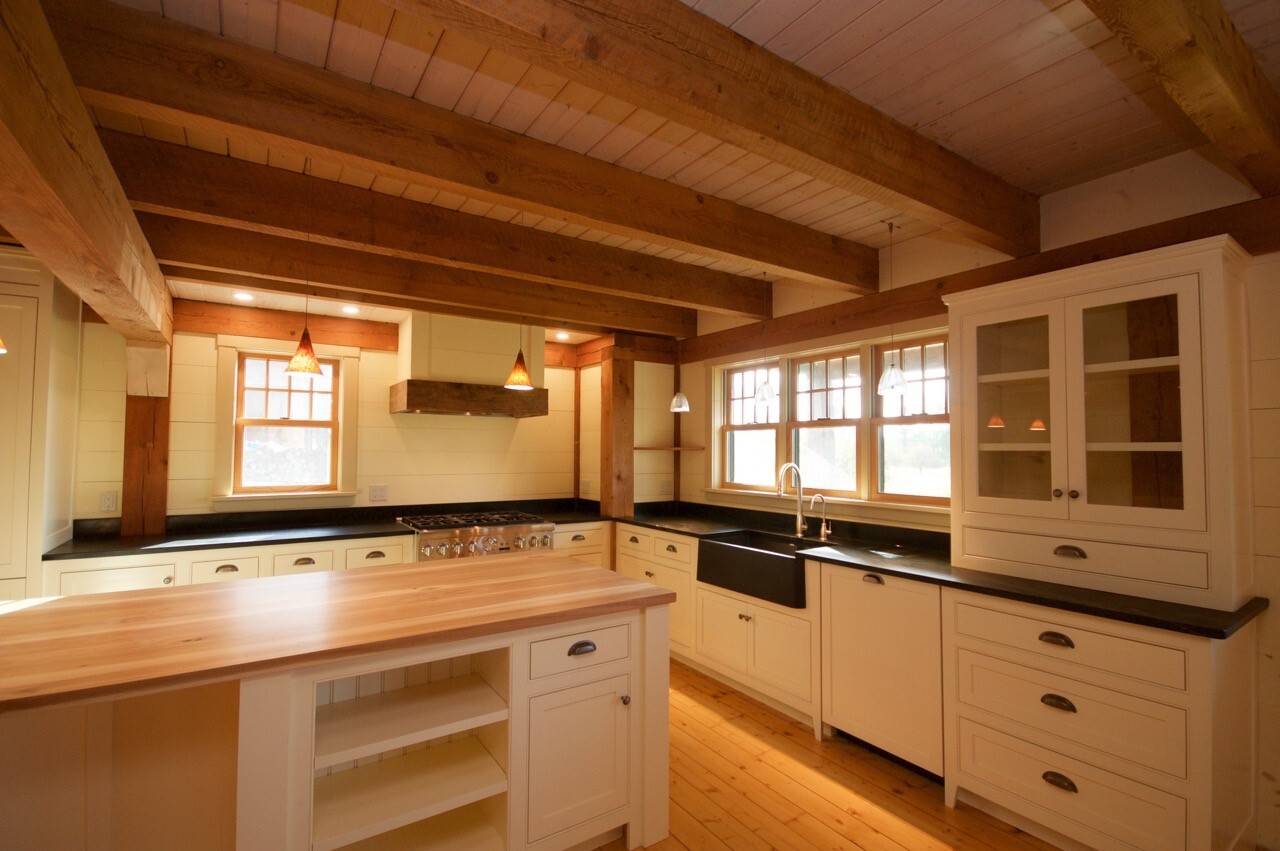 Natural wood kitchen with island and exposed ceiling beams
