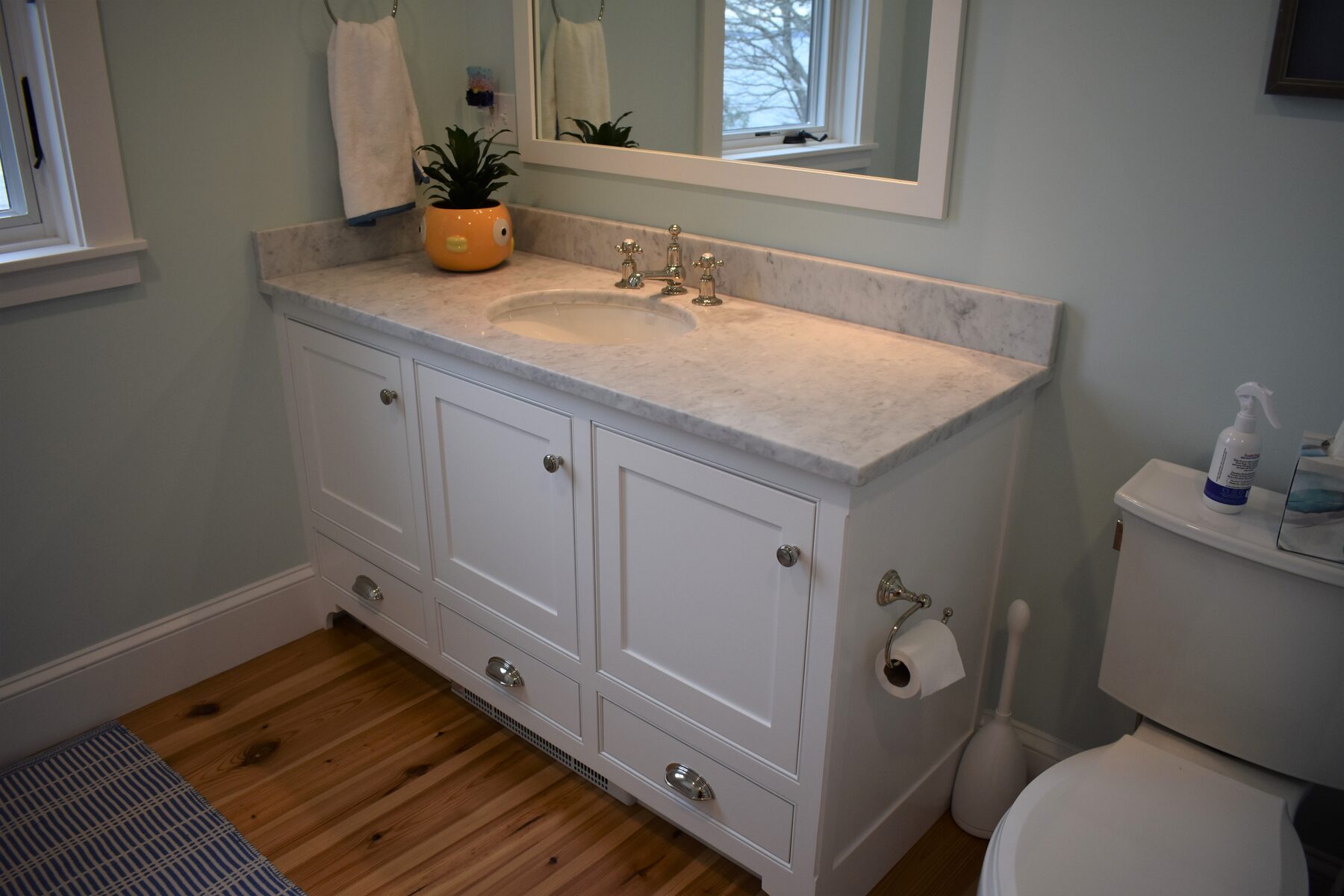 White powder room vanity with marble top