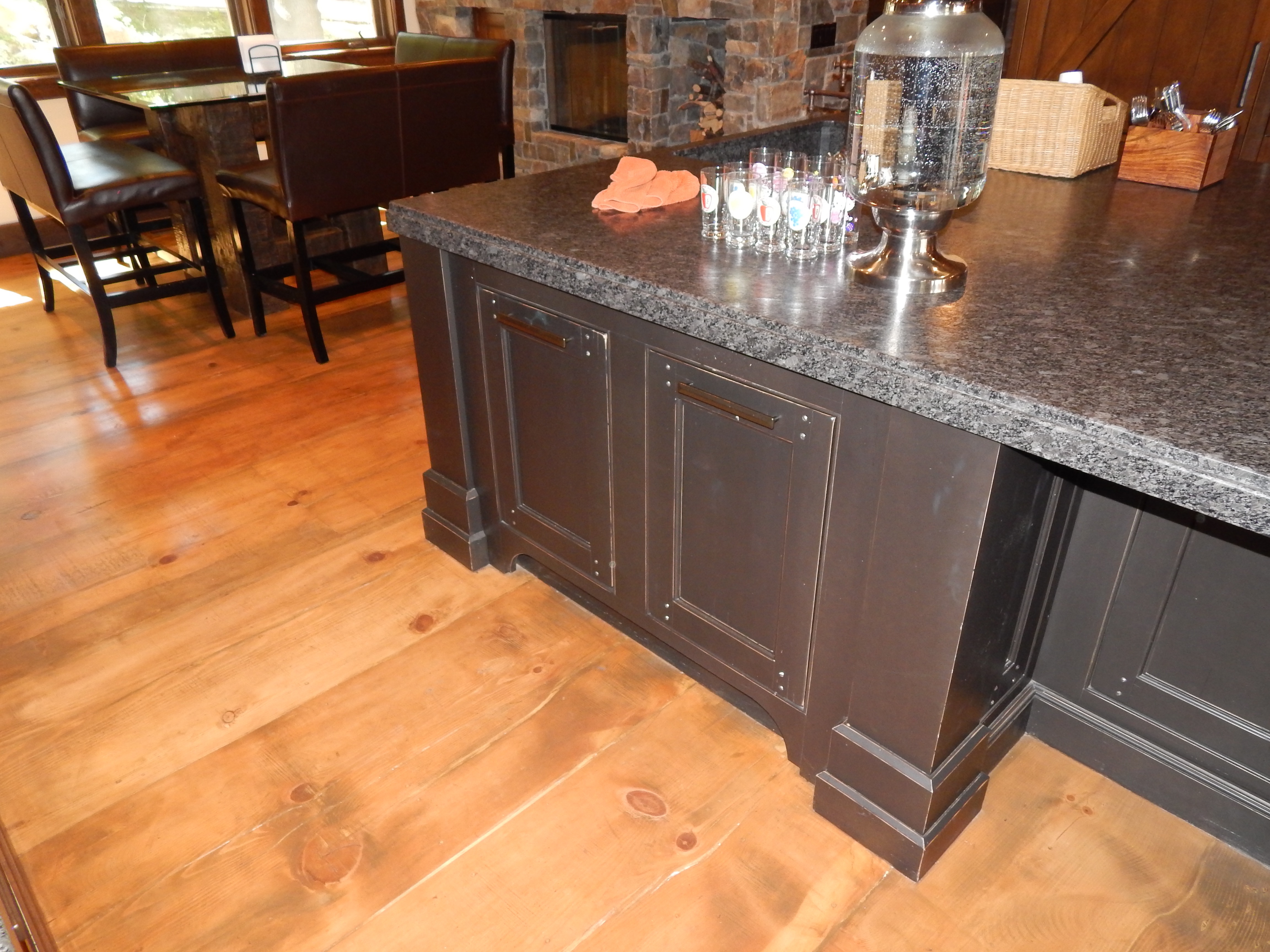 Dark kitchen island counter detail with wood flooring
