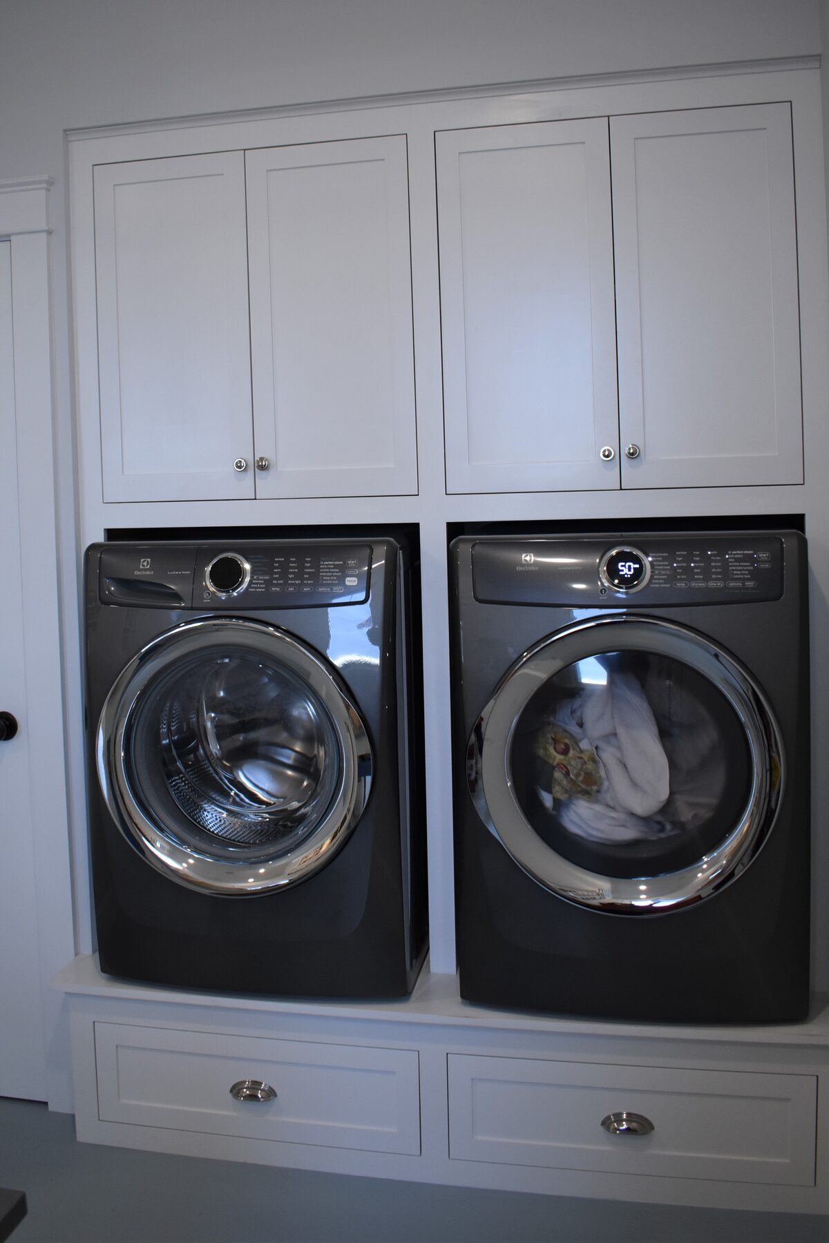 Washer and dryer cabinetry in walk-in pantry