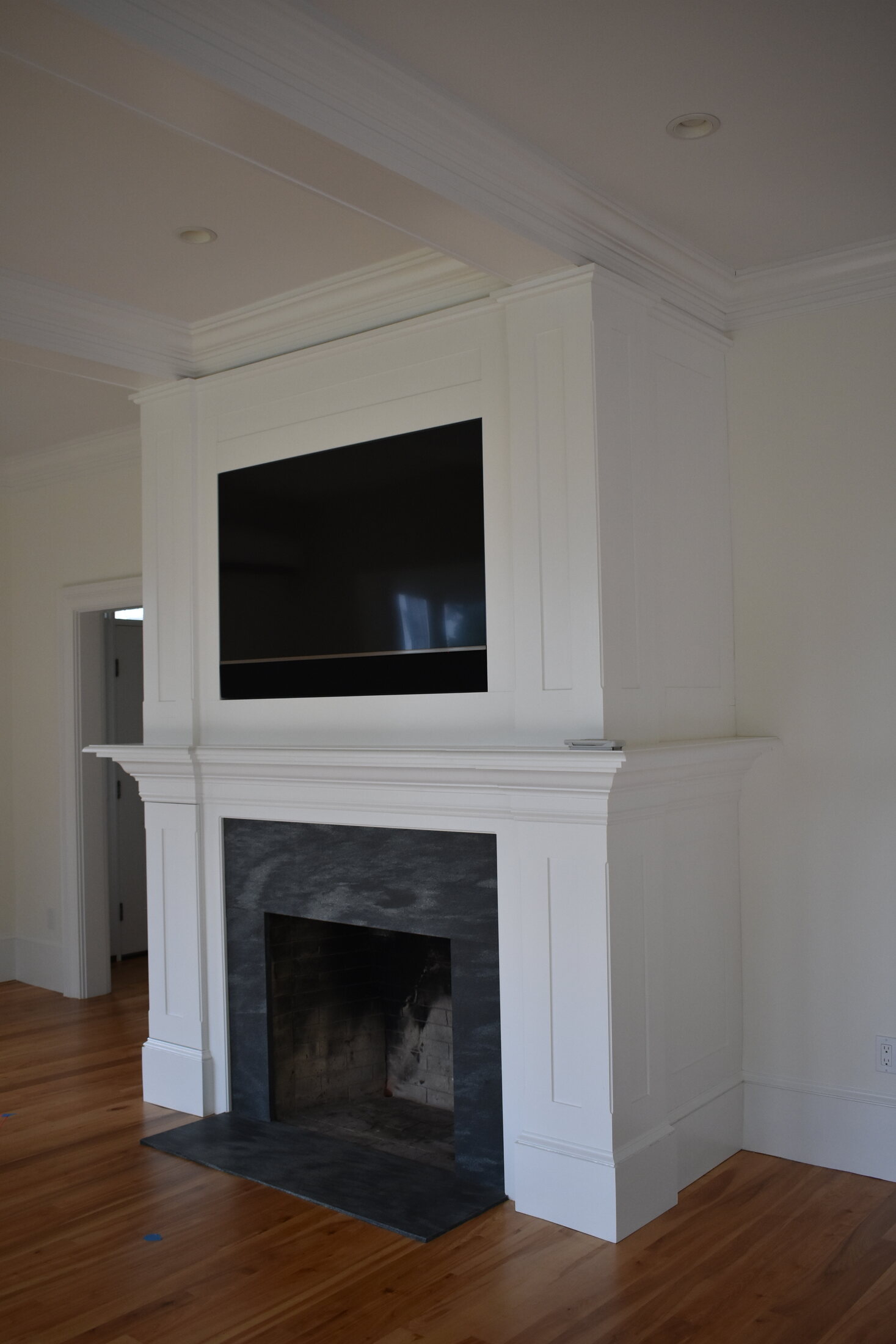 White beverage built-in with wood counter