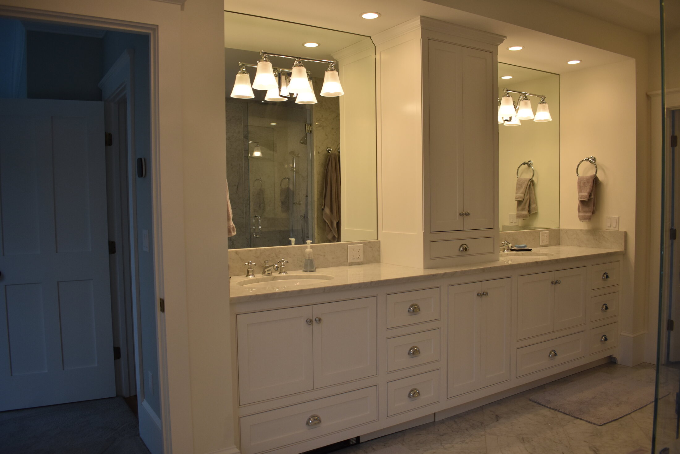 White double bathroom vanity with chandelier
