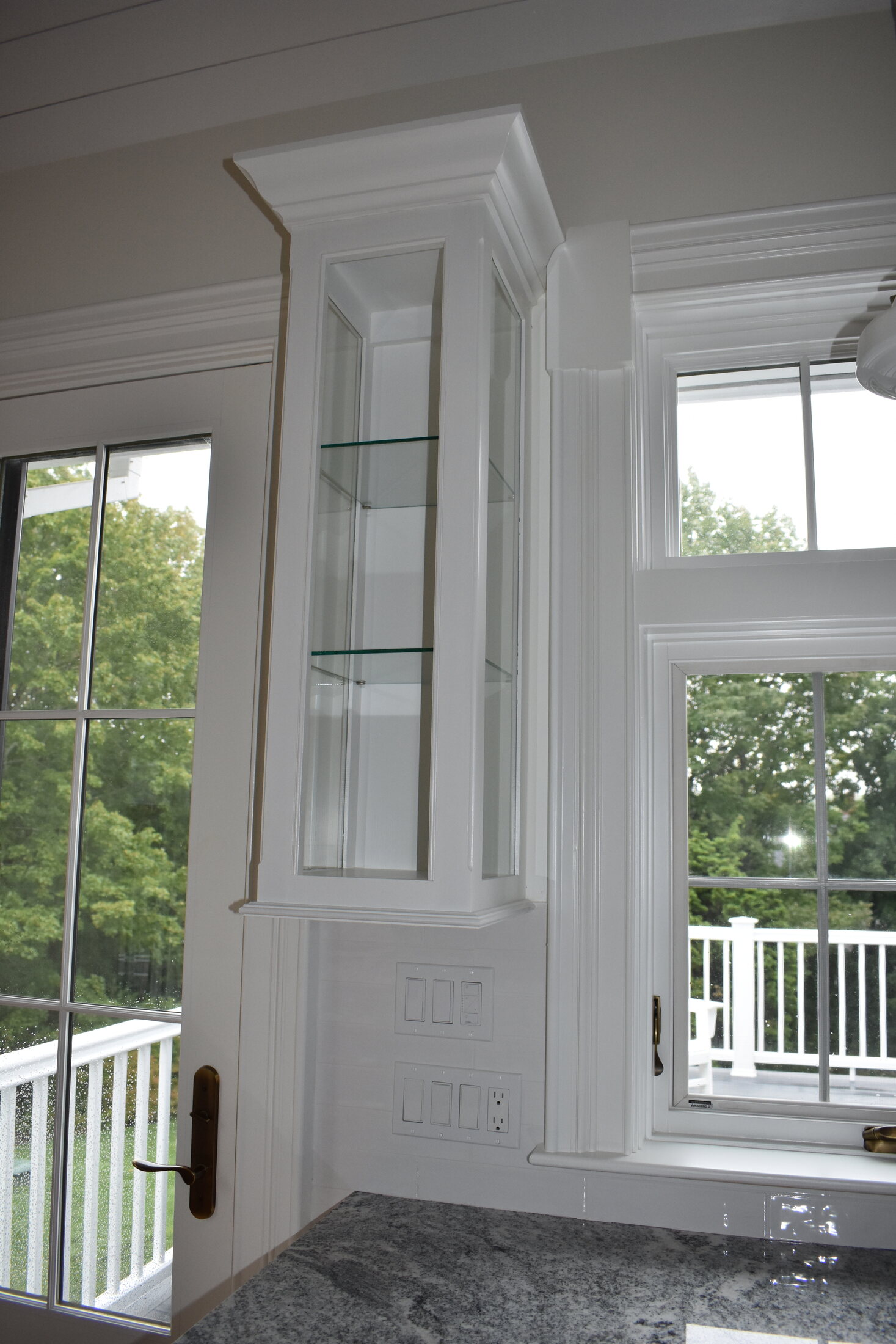 White fireplace built-in with glass cabinet doors