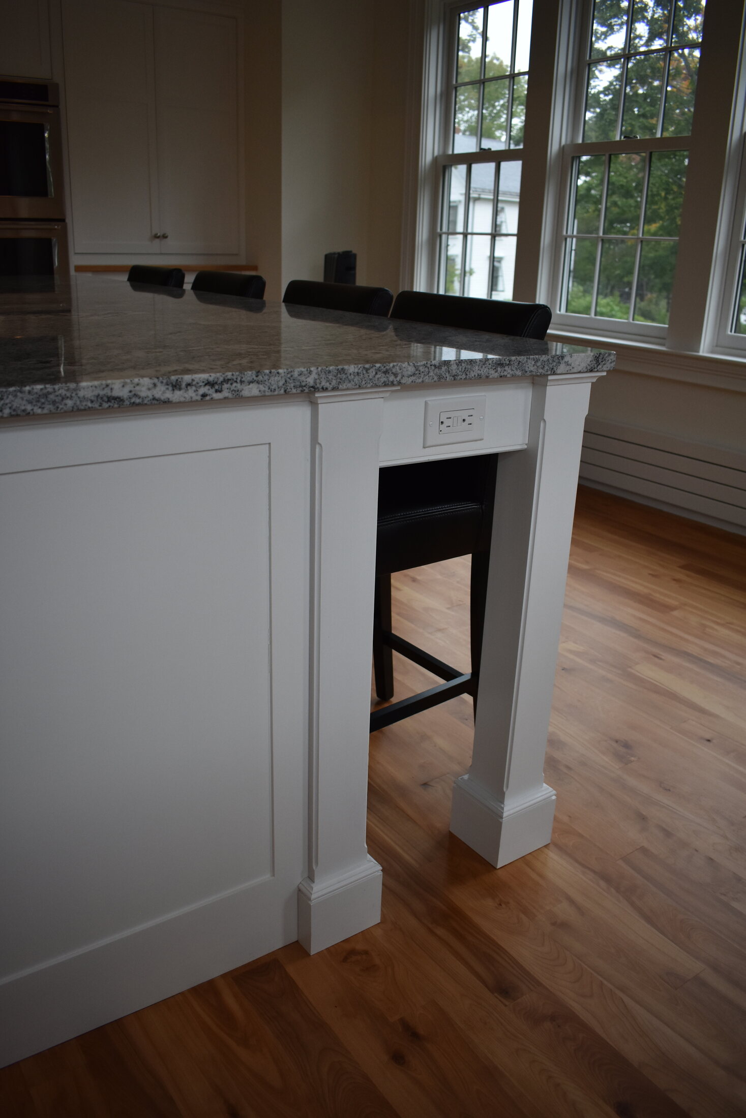 White fireplace built-in beside window