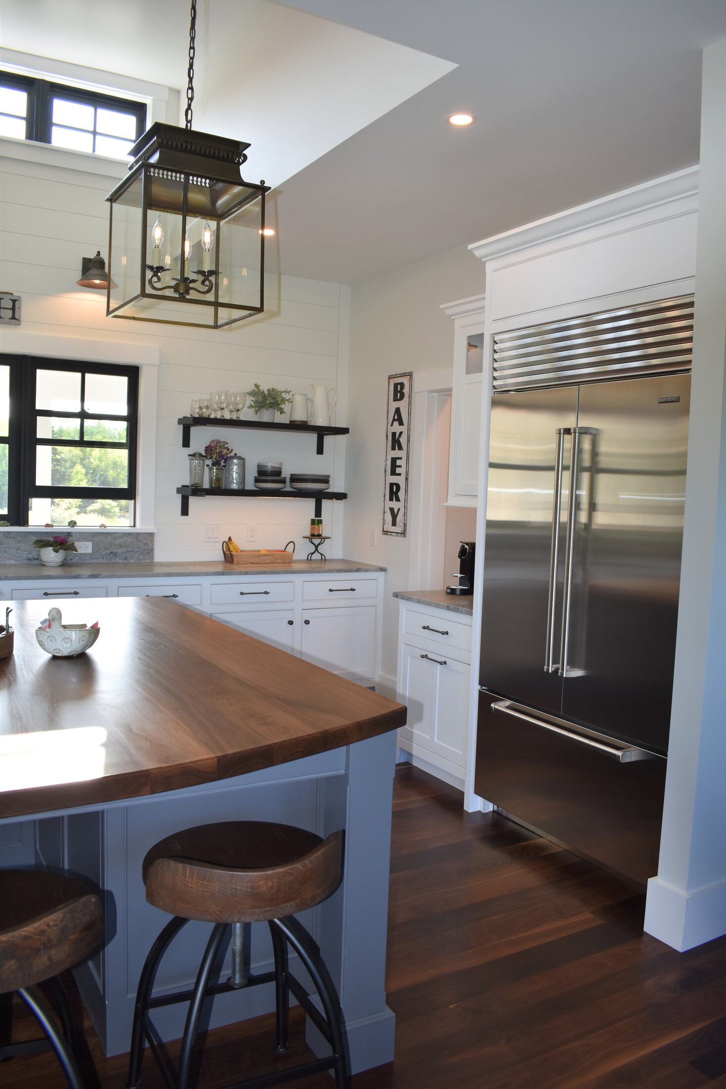 White kitchen island with pendant lighting