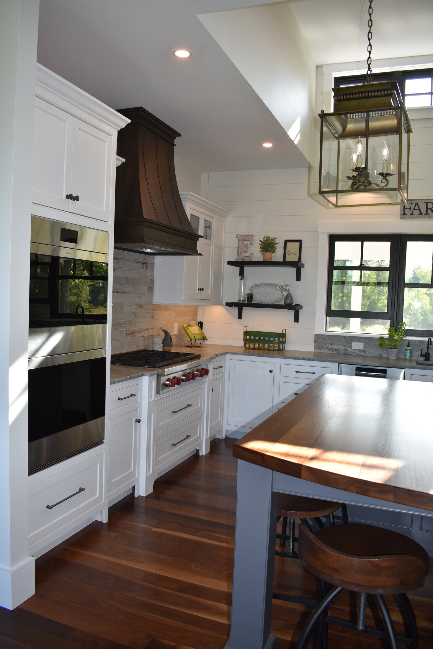 White kitchen range wall with custom hood