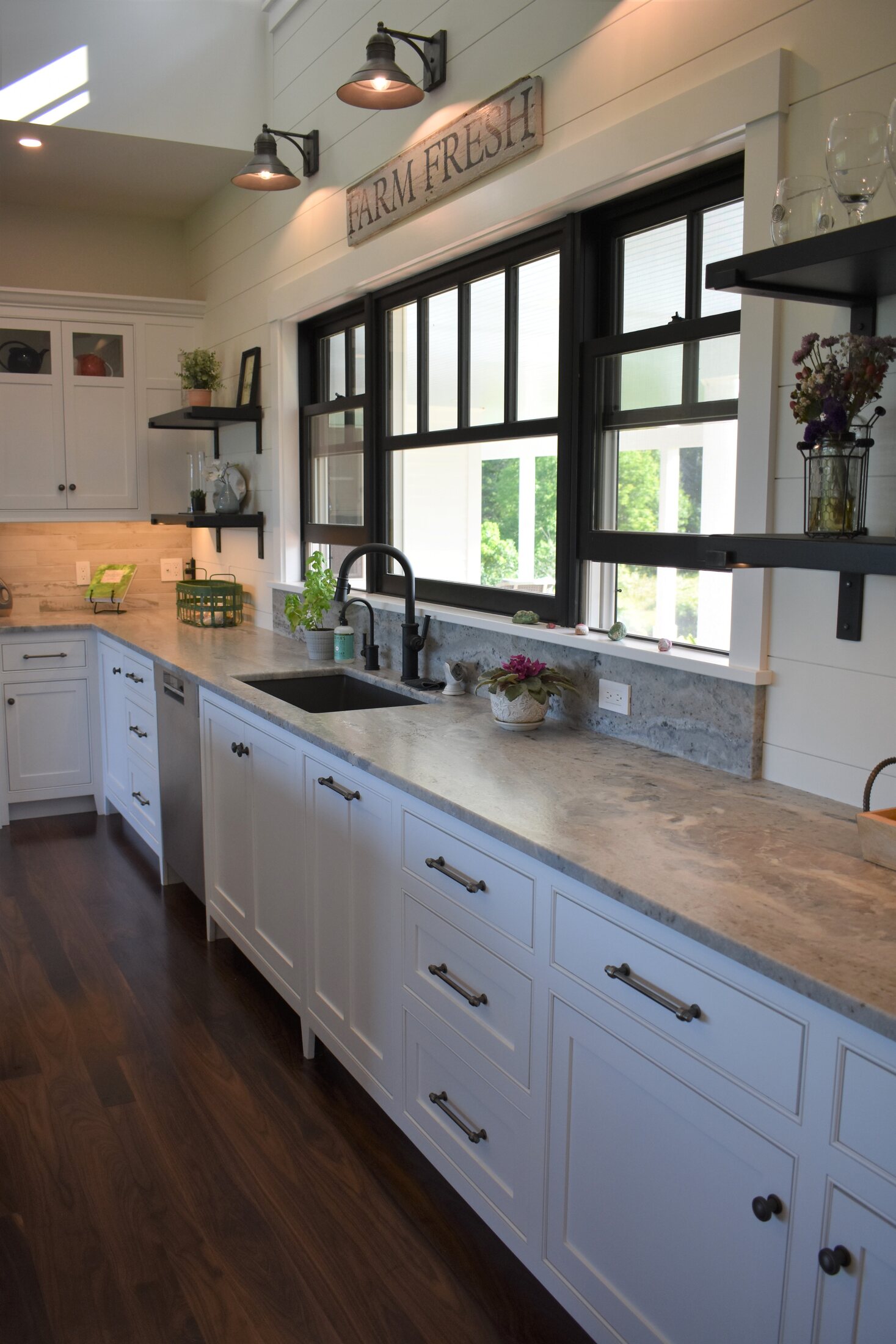 White kitchen sink wall with black windows