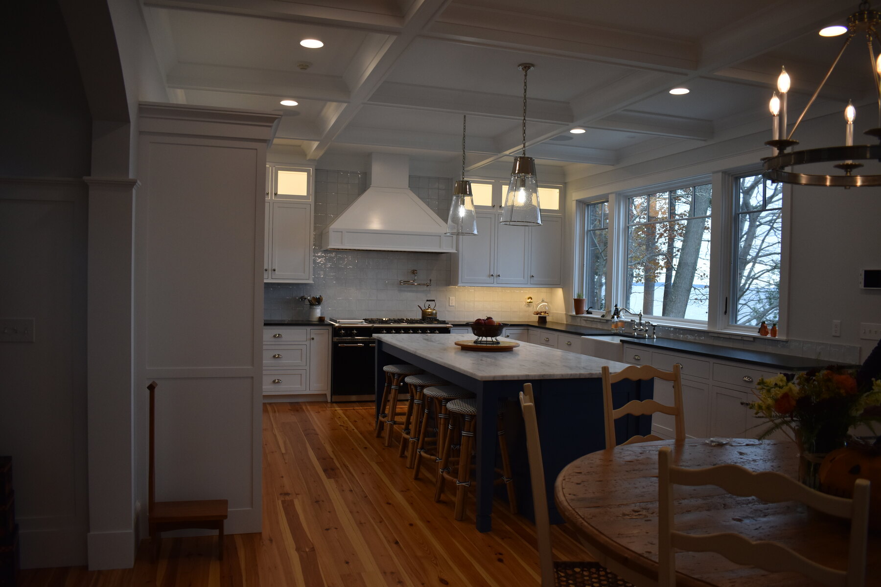 White kitchen with blue island and range wall