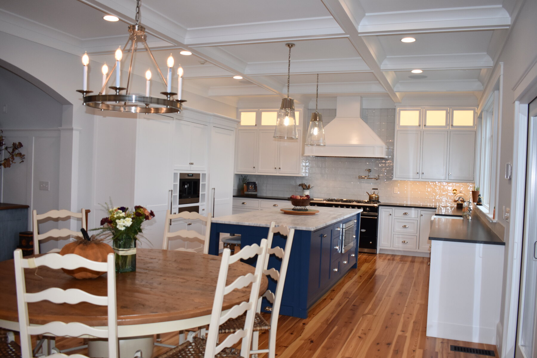 White kitchen with blue island seating area