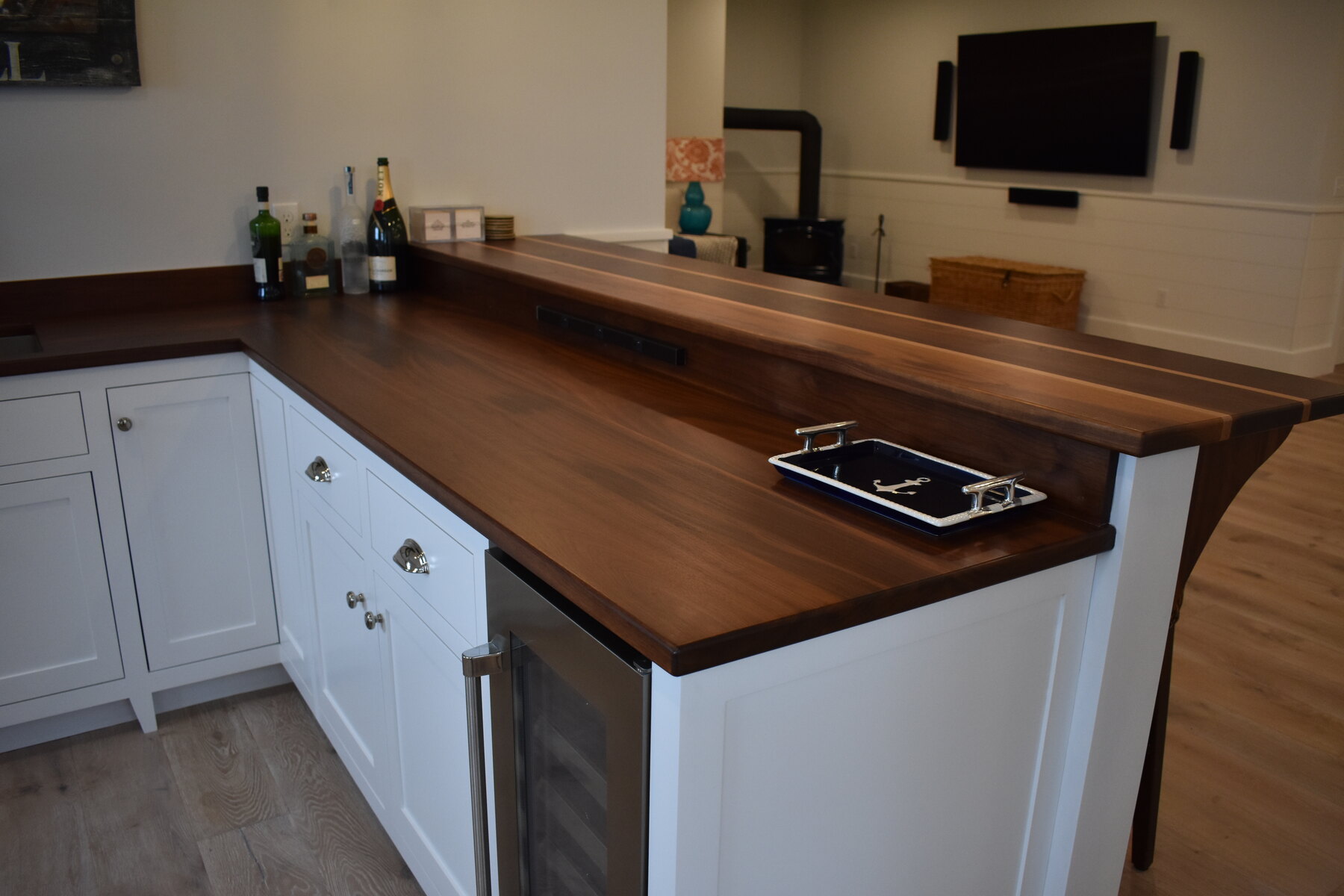 White kitchen with blue island wide view