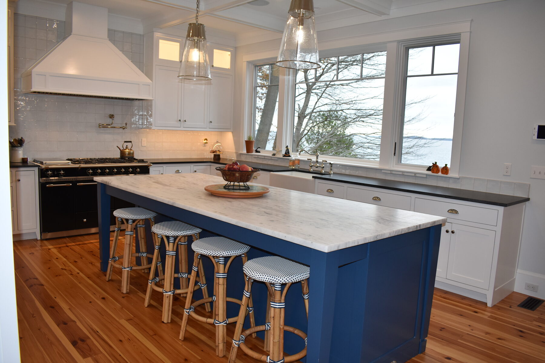 White kitchen with blue island seating
