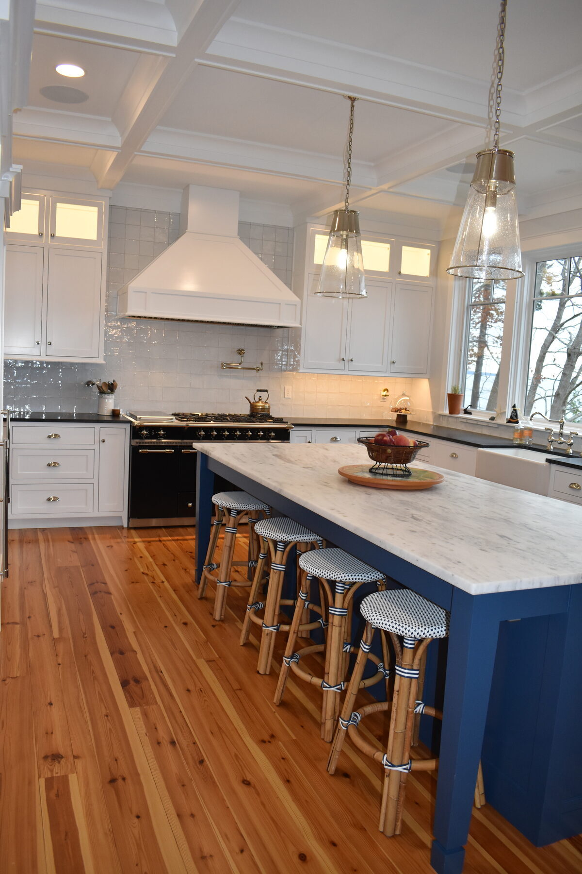 White kitchen with blue island side view