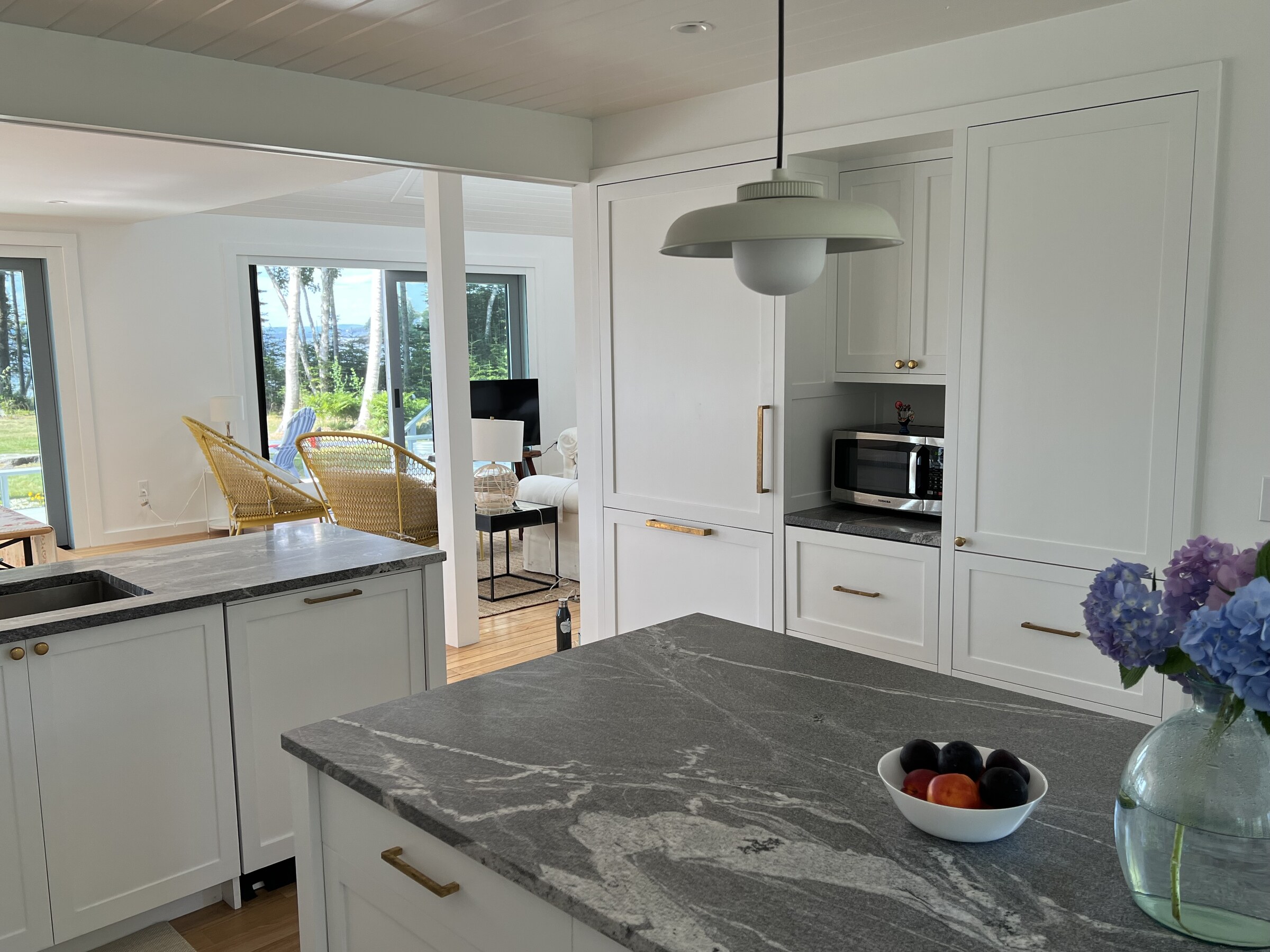 White kitchen island and range wall