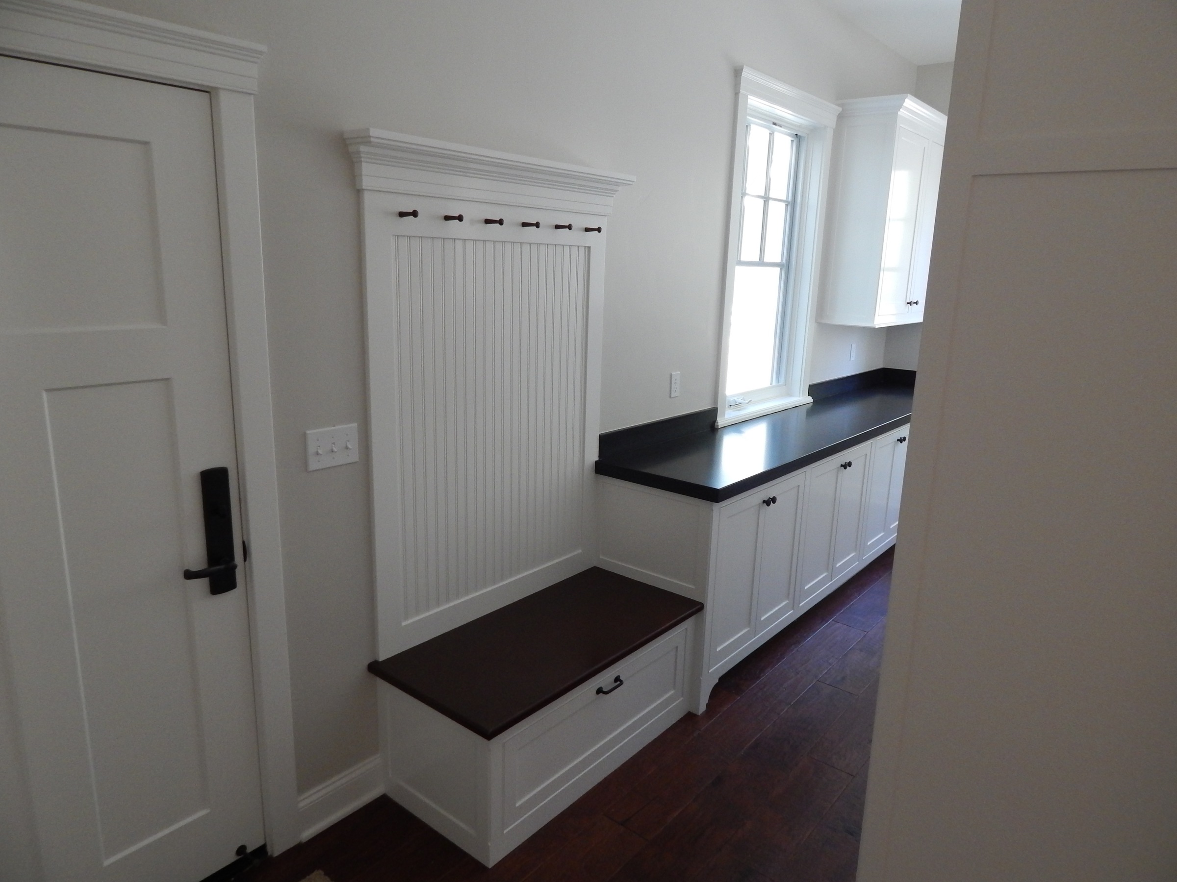 White mudroom storage bench and cabinetry