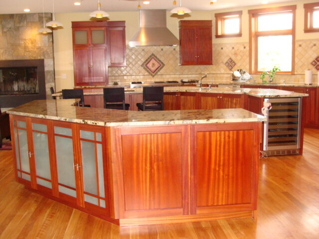 Wood island kitchen with red upper cabinets